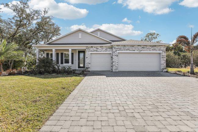 Pre-Construction. To be built. The Harmony captures the spirit of living in North Port, the largest city in Sarasota County—a place surrounded by natural beauty, world-class Gulf beaches, vibrant arts and culture, and the excitement of spring training baseball. With abundant parks and the scenic wilderness of Myakka State Forest nearby, life here blends outdoor adventure with everyday convenience, enhanced by excellent shopping and dining throughout the area.

A spacious corner lot & a covered front porch creates a warm first impression and leads into a welcoming foyer highlighted by 9'4" ceilings. Just off the entry, a versatile Flex Space provides the ideal setting for a home office, dining room, or quiet retreat. A private guest suite with its own walk-in shower ensuite bath adds exceptional comfort for visitors or multi-generational living.

Designed for both daily living and entertaining, the kitchen features a large island, granite countertops, and an adjacent dining area, all flowing effortlessly into the oversized Great Room. From here, step outside to the covered lanai, where stunning views create a relaxing setting to enjoy North Port’s beautiful year-round climate.

Throughout the main living areas, upgraded ceramic tile flooring adds durability and style, while carpeted bedrooms provide comfort and warmth.

The primary suite is a peaceful retreat with a tray ceiling, oversized walk-in closet, and private luxury bath featuring an oversized tiled shower. Two additional secondary bedrooms are thoughtfully positioned to maximize privacy. Completing the home is a side-facing 3-car garage, providing generous parking along with space for a workshop or additional storage.

Modern Smart Home features—including a Ring Video Doorbell, Smart Thermostat, Keyless Entry Smart Door Lock, and Deako Switches—add convenience and peace of mind. Additional highlights include architectural shingles, professional landscaping, irrigation in the front and rear, and a full builder warranty for lasting confidence.

Set within a city known for its parks, outdoor recreation, and proximity to the Gulf Coast, The Harmony blends elegance, comfort, and functionality in a location that truly enhances everyday living. Schedule your private tour today.