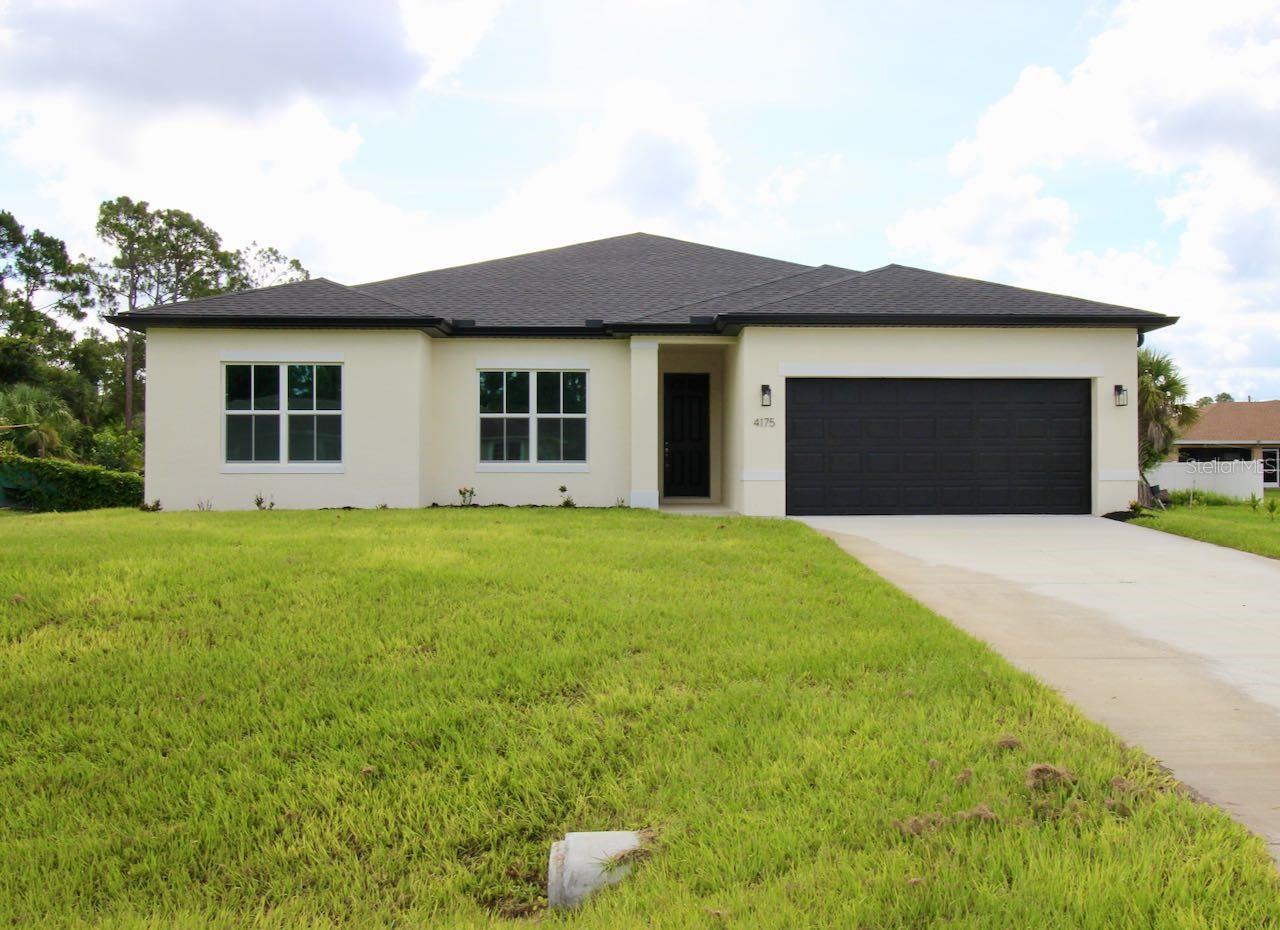 Welcome to this stunning *brand-new* 4-bedroom, 3-bathroom home in the growing community of North Port! Thoughtfully designed with style and functionality in mind, this modern home features an expansive open-concept floor plan filled with natural light, creating a warm and inviting atmosphere from the moment you step inside. The spacious great room flows seamlessly into the beautifully appointed kitchen, complete with soft-close cabinetry, Samsung stainless steel appliances, elegant solid-surface countertops, a subway tile backsplash, and a large center island perfect for entertaining.  The luxurious primary suite serves as a private retreat, featuring two spacious walk-in closets and a spa-inspired en-suite bathroom with a floor-to-ceiling tiled shower and glass enclosure. A second private suite offers its own full bathroom and linen closet, making it ideal for guests, extended family, or a home office setup. Two additional generously sized bedrooms share a centrally located guest bathroom. Triple-panel sliding glass doors and soaring ceilings fill the main living area with natural light and open to the covered lanai, creating the perfect space for entertaining, grilling, or simply relaxing with family and friends. Conveniently located near I-75, shopping, dining, parks, and everyday amenities, this home also provides easy access to world-class fishing, boating, Gulf beaches, and endless outdoor recreation opportunities. Thoughtful design and an exceptional location, this North Port gem offers the perfect blend of comfort, lifestyle, value and no HOA restrictions.