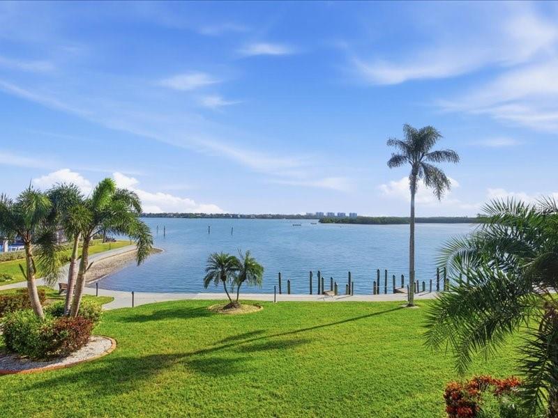 Welcome to Sunrise Cove and the coveted and quiet south end of Siesta Key. This DIRECT BAYFRONT condo is a 3 BEDROOM CONDO and is directly across the road from TURTLE BEACH with plenty of PUBLIC BEACH ACCESS. This condo unit was re-configured and now has three full bedrooms and two full bathrooms. Features include new interior paint, opened and central kitchen, split bedroom floor plan, washer/dryer inside unit, and it comes completely furnished. The open kitchen features a solid beadboard cabinetry, pantry, and plenty of storage. This is an end unit with end unit windows in two of the bedrooms for added light. Relax and look directly out onto Little Sarasota Bay and enjoy wildlife, dolphins, and manatees as well as beautiful sunrises! This condo is super clean and ready to go! There is a storage closet down the hall for beach items and monthly rentals are allowed plus one brand-new carport is included! SUNRISE COVE features 49 boat slips with vacancies, two heated swimming pools, pickleball, tennis, clubhouse with clubroom, fitness room, billiards/ping pong, kayak storage, BBQ grill with gazebo, and public beach access directly across the street! This is a super well-run and manicured complex and is very near to two delicious restaurants. This south end of Siesta Key is very quiet. Come see this beautiful beach and waterfront condo today!
