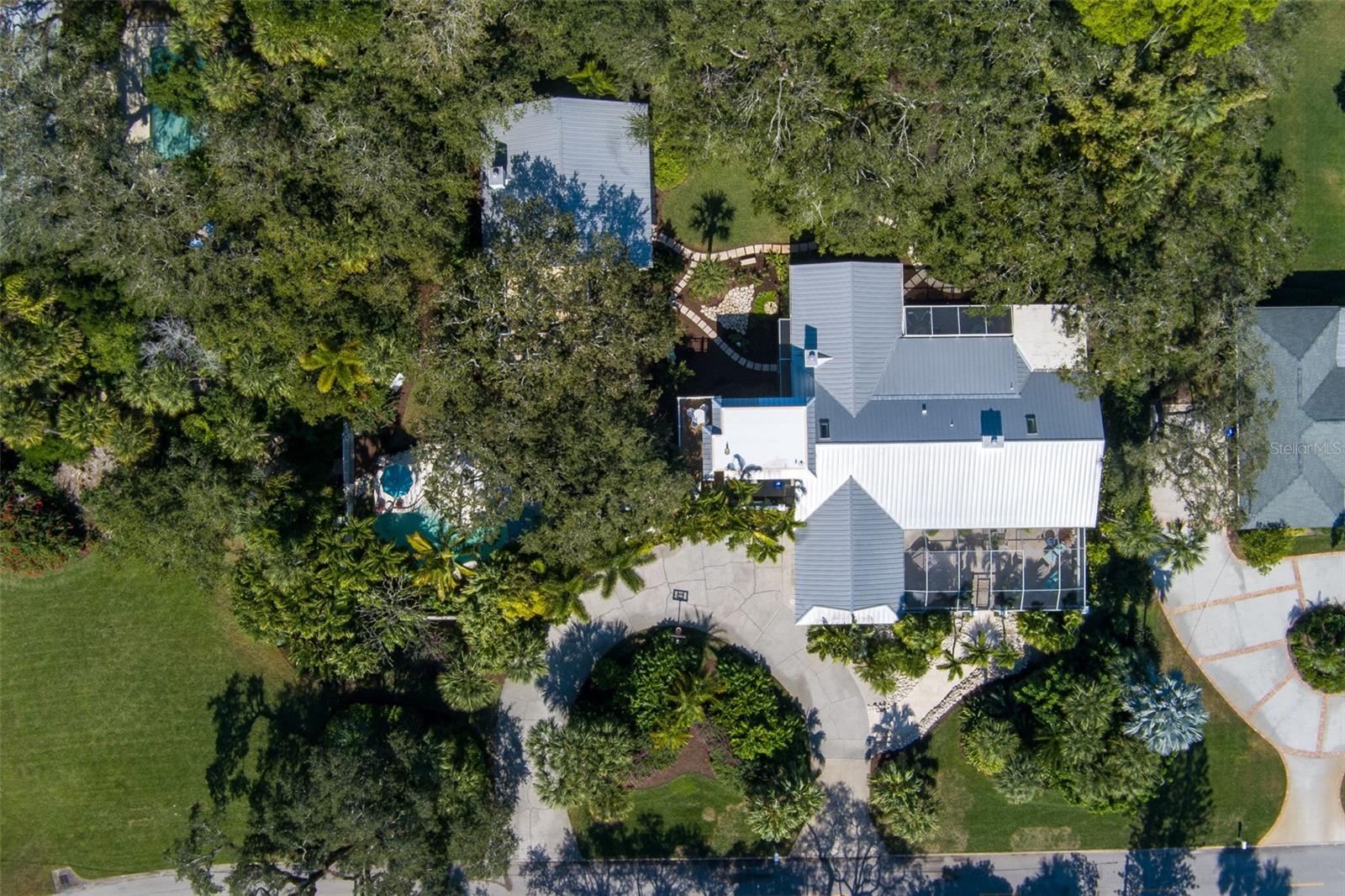 Skinny dip in total privacy in this 1 acre+ central beach estate in pristine condition. Ideal entertaining home perfectly designed for island living - every room leads to a screened patio. Enjoy your morning coffee in a botanical garden setting or an evening glass of wine with gorgeous sunsets above your lagoon shaped pool. Easy walk to dine, shop, theater, museum, tennis, river & ocean. Effective year built 1990 (original house built 1976, gutted and rebuilt 1990 - added in 1990 poolhouse, wall, master bath, guest suite, study, sleeping porch, lanai, 4 screened porches.