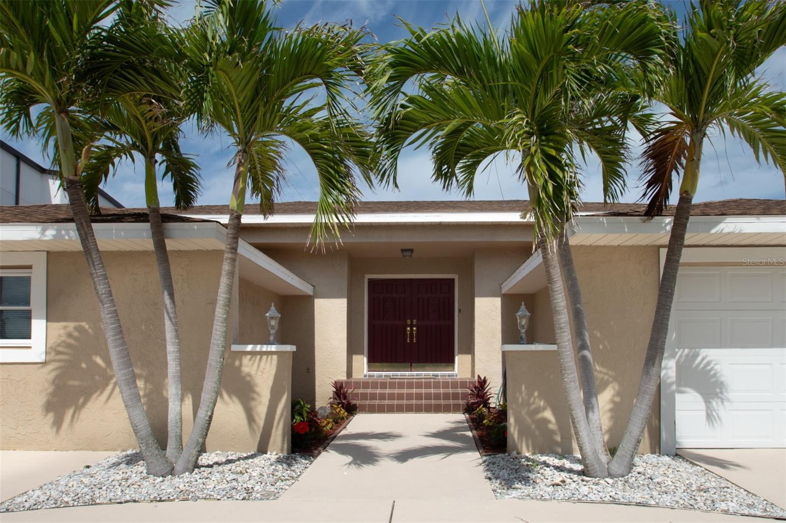 Virtually Staged. Virtually Staged. Virtually Staged. Just a stones throw from the resident only Belleair Beach! Live like you are on vacation every day in this lovely home located steps from Belleair beach, only accessible by residents. Enter the foyer through double solid wood entry doors and be impressesed by the full size, completely PRIVATE pool in the center of the home. Open the many sliding doors and make the pool area part of your daily living space. Experience a Resort feel with the ultimate privacy. Solidly constructed, this unique home showcases an eat-in kitchen with diagonally laid tile, solid wood cabinetry, granite counters, stone back splashes, stainless steel appliances, breakfast bar and tray ceilings. The family room features valuted ceilings, a stone wood burning fireplace and inlayed tile work. With 5 bedrooms, there is plenty of space to house family and guests. The fifth bedroom can easily be converted to a game room by stowing the built-in murphy bed to provide even more area to entertain and relax. ALL bathrooms have been recently updated. The two car garage and large circular driveway provides plenty of off-street parking. An additional welcoming feature is that this sturdy home is built up to nearly 10 feet above sea level, yet still constructed on a slab. Located close to shopping, fine dining, community boat ramp, community park and tennis courts. INVESTOR ALERT!! Hot area with rapidly growing equity. Can do a minimal remodel & resell at a price well worth your effort! OR move in as is and live in beautiful Belleair Beach! Some images are virtually staged. Home comes partially newly furnished! Qualified buyers purchasing this home using Simplified Mortgage as their lender can receive a lender credit of $500 for each $100k in loan amount (up to $5000). Lender credit can be used towards closing costs and/or interest rate reduction. This credit is in addition to any concessions negotiated in the transaction.This credit is in addition to any concessions negotiated in the transaction