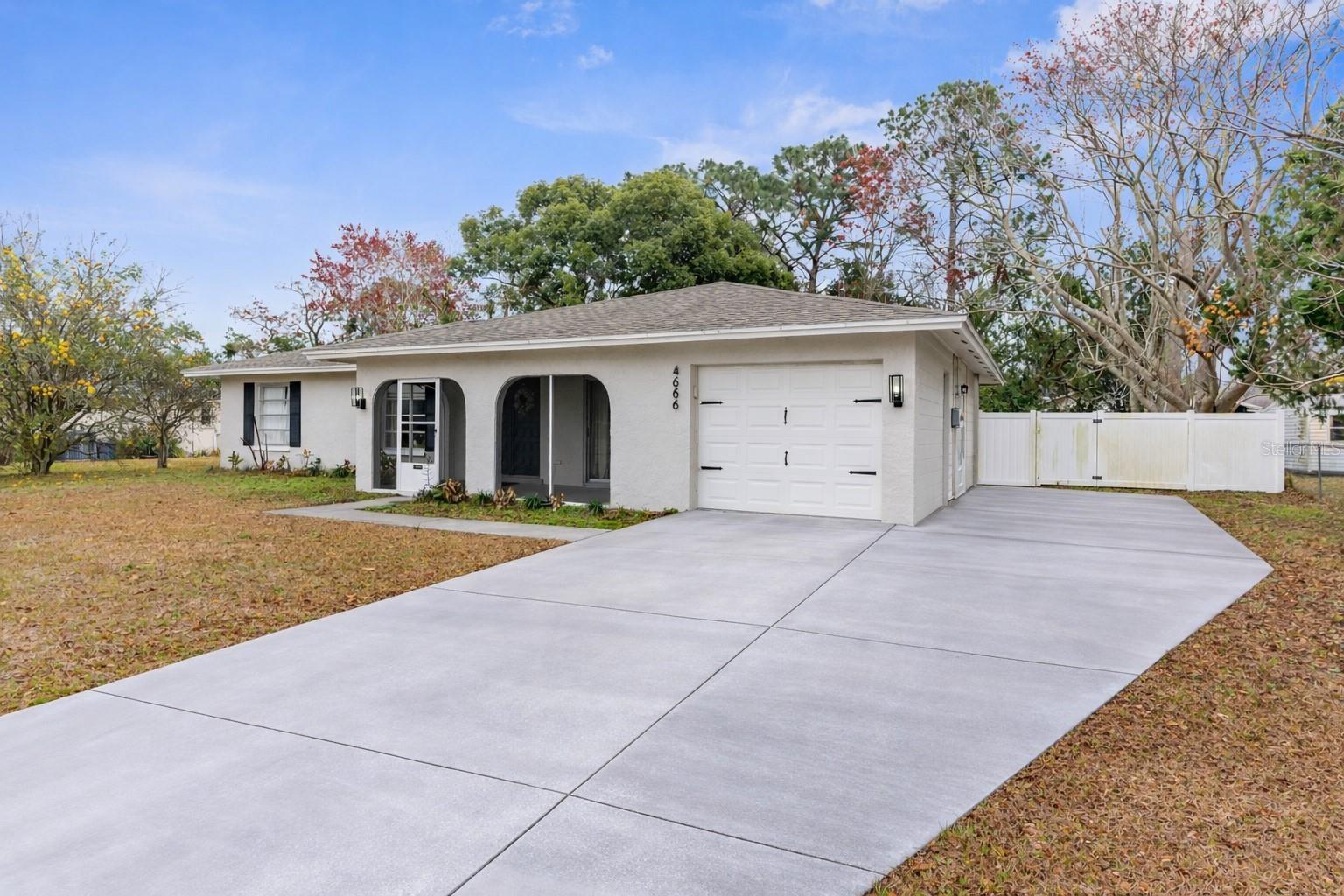 This charming 3-bedroom, 2-bathroom, 1 car garage home in Spring Hill, Florida, offers the perfect blend of comfort and convenience on an oversized, FENCED IN lot. Recently updated with modern finishes, the home features, a newer AC unit (2022), a newer roof (2021), updated flooring and new carpet in the bedrooms, and a renovated kitchen with sleek countertops, beautiful backsplash and newer appliances. Spacious living areas provide plenty of room for both relaxation and entertaining, while the generously sized lot offers endless possibilities for outdoor activities, gardening, or future expansion. The driveway is expanded and has room for RV or boat parking OR could be turned into a private basketball court for fun! Large screened in and covered back porch make outdoor living enjoyable. Located in the heart of Spring Hill, with great schools, this affordable, move-in-ready home is a true gem with all the upgrades you're looking for! Call today for more information before this one is gone!
