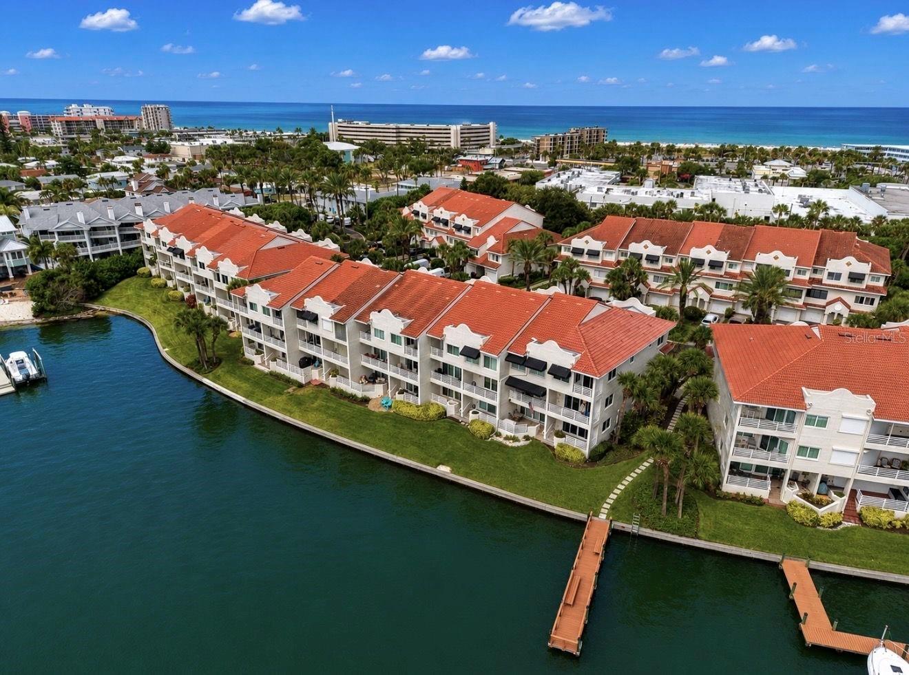Virtually Staged. Wake up to spectacular sunrises over Boca Ciega Bay and enjoy the ultimate St. Pete Beach lifestyle in this beautifully updated waterfront end-unit townhome in the desirable Mirabella community. Available for a minimum 6-month lease, this spacious residence offers the perfect combination of luxury, comfort, and flexibility. Enjoy breathtaking water views from three private balconies, providing the perfect setting for morning coffee, evening cocktails, or watching dolphins and manatees play in the bay.  The versatile floor plan includes a private lower-level suite with a full bath, wet bar, queen Murphy bed with built-in closet storage and shelving, and direct access to the waterfront patio—ideal for guests, multi-generational living, or a private home office.  The main living level features an open-concept design with walls of glass overlooking the water, a beautifully updated kitchen with marble countertops, stainless steel appliances, induction cooktop, wine cooler, oversized porcelain farmhouse sink, and abundant cabinetry. The spacious living and dining areas open to a waterfront balcony, making entertaining effortless.  Upstairs, the primary suite is a peaceful retreat with soaring ceilings, panoramic water views, a sitting area, two walk-in closets, and an updated ensuite bath. Also on the upper level are a second bedroom, a full bathroom, and a convenient laundry area.  Additional features include new impact windows and sliding glass doors (2025/2026), a new tile roof (2025), fresh interior paint, awnings, an oversized one-car garage, double-wide driveway, abundant storage with overhead garage storage, under-stair storage, attic storage above the primary bedroom, and generator-ready electrical infrastructure. Mirabella offers the perfect coastal lifestyle with a heated community pool, fishing pier, kayak launch, day dock, guest parking, beautifully maintained grounds, and a pet-friendly community. Just a short walk to the sugar-sand beaches of St. Pete Beach, waterfront restaurants, shopping, and entertainment, you'll enjoy everything Florida's Gulf Coast has to offer.  Available for a minimum 6-month lease. Seasonal rate (January-April): $6,950 per month. May-December: $5,795 per month.
