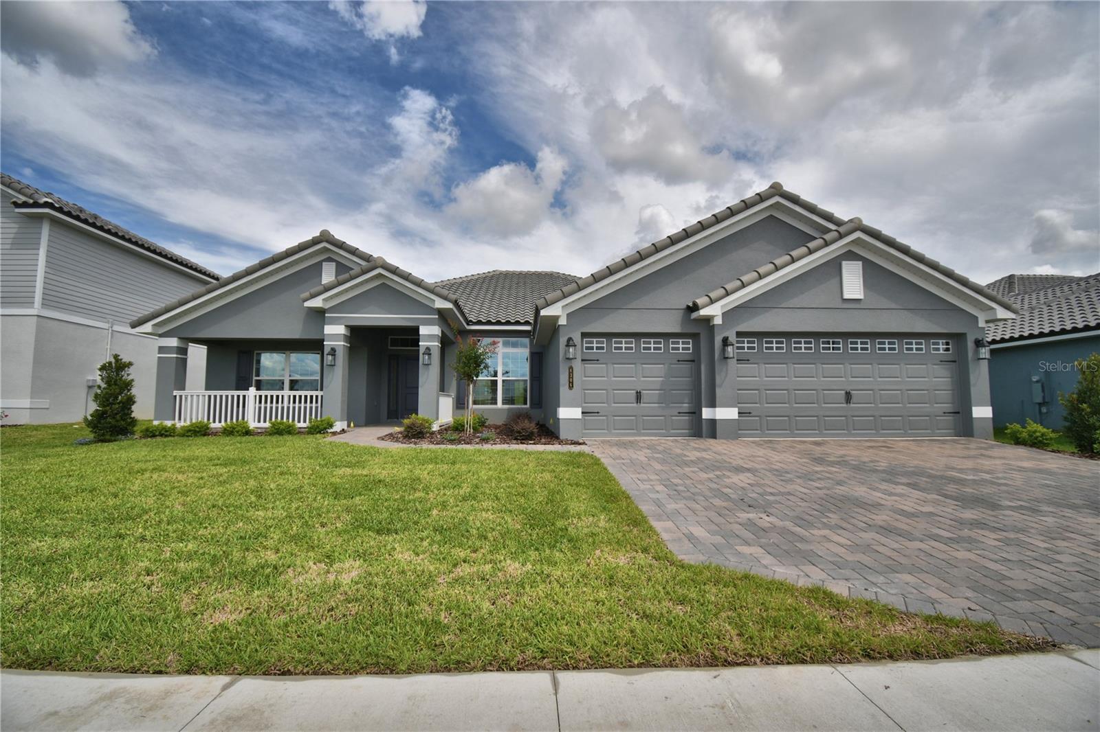 Under Construction. This 2500 Sq ft home has 4 bedrooms and 3 baths, 3 car garage, lots of entertaining space and luxurious details throughout! Upon entering you will enjoy the open concept great room/dining room/kitchen with 10’ ceilings, wood look plank tile in main areas, granite countertops throughout, 5 ¼ inch baseboards, wainscotting in dining room and much more. The owner suite is spacious with Tray Ceiling w/crown molding. Ensuite has double sink vanity with extra storage drawers, linen closet, tile separate shower w/glass door, nice tub, etc. This home has 3 other spacious bedrooms and 3 baths with linen closet, tub-shower combo, separate toilet, duel split vanity sink with storage drawers. The exterior of the home has a tile roof and patio paver driveway, and patio paver covered lanai. This community is gated, has a gorgeous clubhouse with fitness center, pool overlooking the lake, basketball and tennis courts.