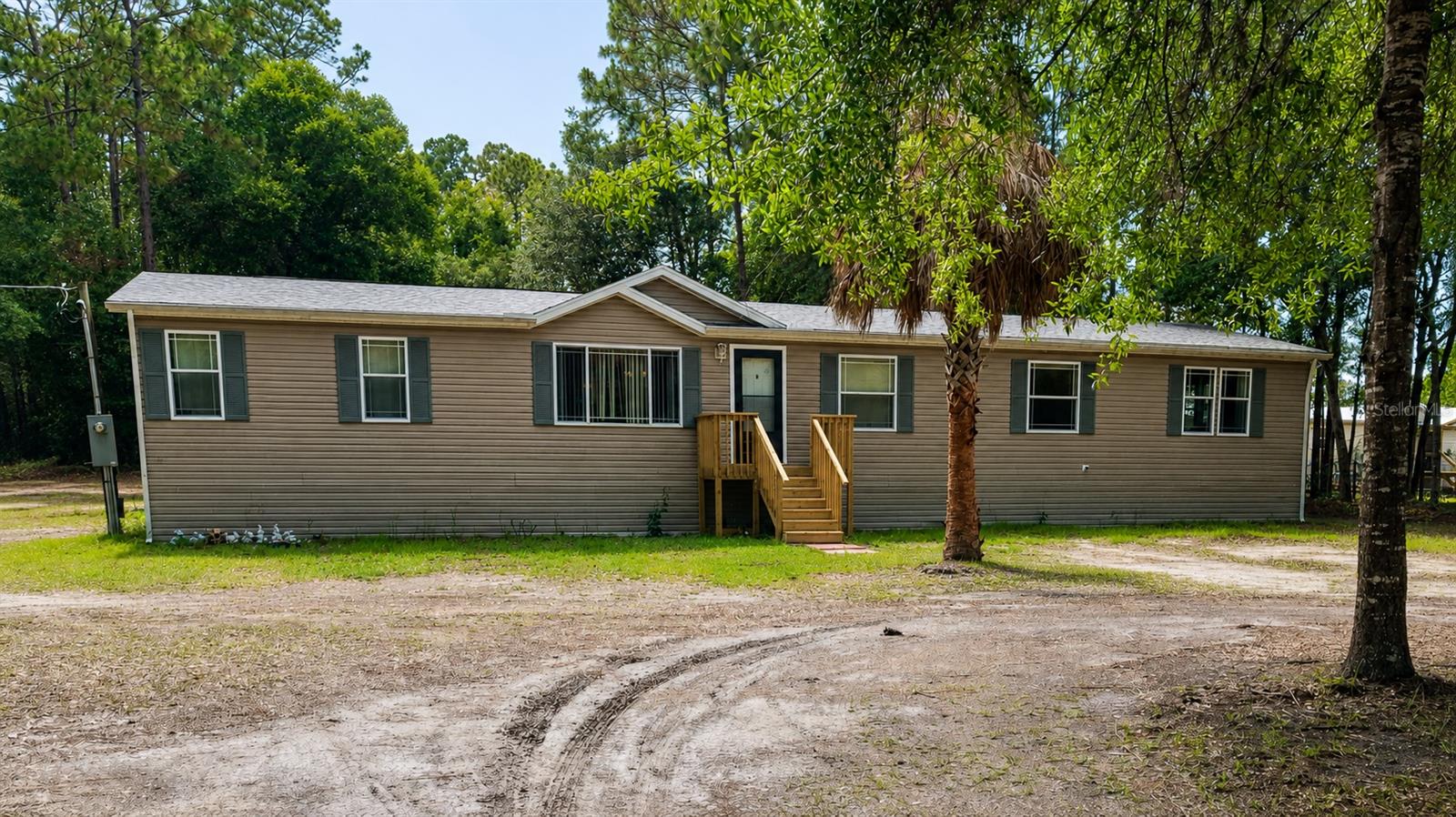 Tucked away on 2.13 private acres in the heart of Homosassa, this stunning 4-bedroom, 2-bath home offers the perfect blend of space, comfort, and tranquility. Set far back from the road and framed by a beautiful line of mature trees, the property creates a secluded sanctuary feel from the moment you arrive.

Inside, you’ll find 2,356 square feet of thoughtfully designed living space featuring an oversized kitchen with abundant cabinetry and counter space, ideal for entertaining, large gatherings, or everyday living. In addition to the four spacious bedrooms, the home also features a large private den complete with a cozy fireplace, making it the perfect flex space for a home office, media room, or quiet retreat.

The expansive primary suite offers a relaxing escape with a spacious bathroom featuring a shower, dual vanity, and a walk in closet. A large laundry room provides added convenience and functionality.

Recent updates include a 2023 roof and 2020 HVAC system, offering peace of mind for years to come. Brand-new wood staircases enhance all three entryways, adding warmth and charm to the exterior. 

Step outside to enjoy the covered wood deck overlooking the peaceful backyard, perfect for morning coffee, evening sunsets, or enjoying the natural surroundings. The property also features a storage shed with power already in place, offering versatile space for storage, workshop projects, hobbies, tools, equipment, or recreational gear.

If you’ve been searching for privacy, acreage, and a move-in ready home with character and space to breathe, this Homosassa retreat delivers it all.