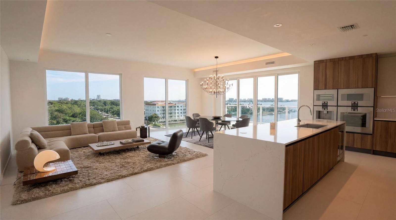 One or more photo(s) has been virtually staged. LUXURY LIVING at SERENA BY THE SEA - "PH 609" is a special southwest corner residence offering panoramic vistas over the intracoastal waterway to Clearwater Beach and the Gulf of America, including 3 Bedrooms and 3.5 Bathrooms in approx. 2,572 SF of interior space, PLUS a 374 SF west-facing private terrace. Its spacious corner Living & Dining Room offers tons of natural light with both south and west exposures, is open to the Kitchen, and has sliding glass doors to the expansive terrace - perfect for al fresco dining with Florida's famous Gulf Coast sunsets as your backdrop. The gourmet Kitchen features a large island bar with waterfall edges, complimented by top-of-the-line Gaggenau appliances including a 5-burner gas cooktop, paneled refrigerator and dishwasher integrated within the Italian cabinetry, a wine cooler, and "The Cube" package with wall oven, speed oven, coffee & espresso maker, steam oven, and vacuum sealer.  A spacious Den/Family Room is adjacent to a Powder Room convenient for guests. Luxurious finishes continue throughout the 3 Bedroom Suites each with direct water views, en suite Bathrooms, and designer closets. The Master Bedroom uniquely features its own sliding glass door to the terrace, His & Her walk-in closets, and the Master Bath boasts a wet room with double shower and soaking tub set beside a picture-perfect window overlooking the intracoastal waterway. 
SERENA BY THE SEA is THE premier luxury condominium in Clearwater with 23,000+ SF of amenities including 24/7 concierge, a self-service Spa (massage room, hair salon, sauna, jacuzzi, more), gym/fitness center, social room with lounge, billiards and poker tables, banquet-sized dining table, full kitchen, plus outdoor resort-style saltwater swimming pool and jacuzzi deck overlooking the intracoastal with poolside cabanas, daybeds, abundance of lounge chairs, 2 summer kitchens with BBQs & TVs, pool bathrooms + outdoor shower, fire lounge, dog-friendly, and more. Call to schedule a private showing today.