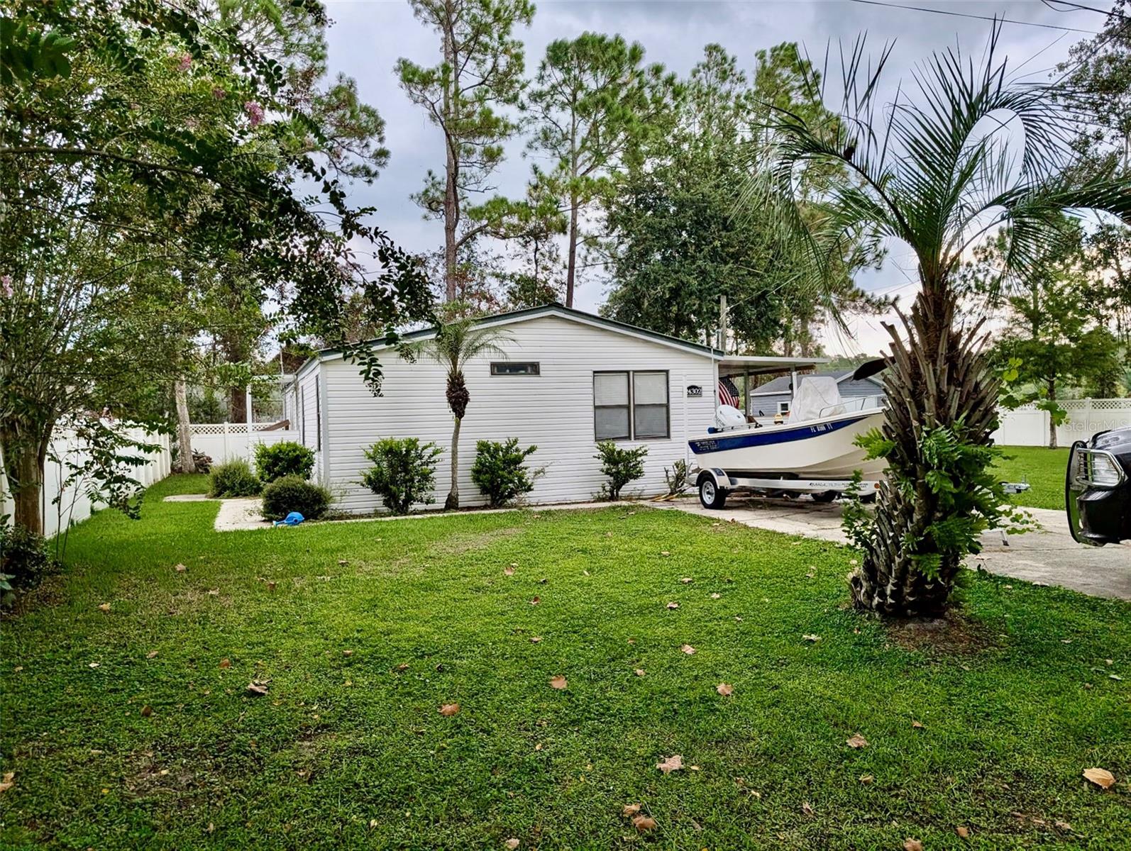 Very well kept 3 bedroom, 2 bathroom manufactured home on a double lot with beautiful 6 ft vinyl privacy fence. This home offers lots of space inside for family as well as a large yard! This property is next door to the ball fields, dog park, public library, and within 2 miles of the public boat ramp. This quiet little community features public water and sewer, and is surrounded by the Ocala National Forest. On a paved road, not in a flood zone, this is a great property for an affordable price.