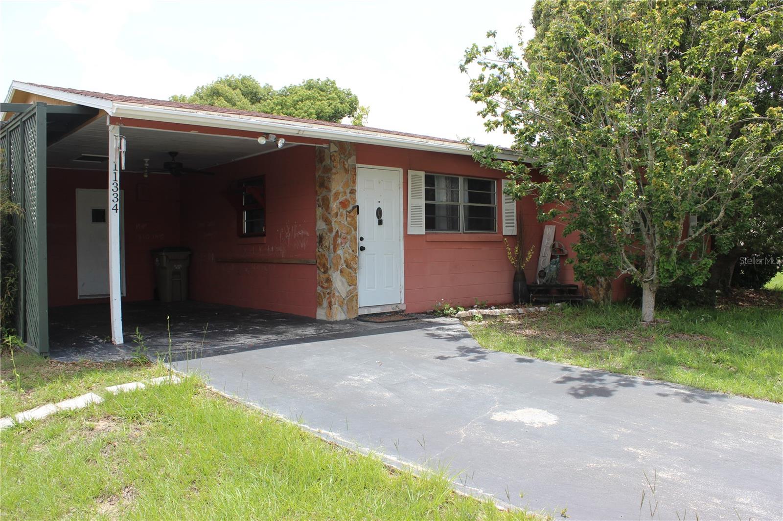 Welcome to this charming 3-bedroom, 1-bath home situated on a spacious 0.46-acre lot. The property features a carport, detached garage/workshop, and a fenced backyard, offering plenty of room for storage, hobbies, and outdoor enjoyment. Inside, sliding glass doors open to a screened porch, creating the perfect space to relax and unwind. Step outside to the covered patio, which overlooks a peaceful backyard setting ideal for entertaining, gardening, or simply enjoying nature. Conveniently located near shopping, restaurants, entertainment, schools, and medical facilities, this home combines comfort, functionality, and accessibility. Schedule your private showing today and discover all the possibilities this property has to offer!