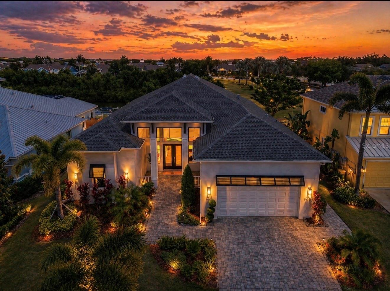 Welcome to this stunning custom-built home by Bartlett Custom Homes, offering over 2,800 square feet of thoughtfully designed living space in the highly desirable MiraBay community. This 3-bedroom, 3-bath residence plus a designated office perfectly blends luxury, comfort, and craftsmanship.  From the moment you step inside, you’ll be captivated by soaring high ceilings, elegant custom beams, beautiful shiplap accents, a modern slat wood feature wall, and a stylish electric fireplace. A striking glass-enclosed wine cellar adds a true designer focal point, creating a warm yet sophisticated coastal feel. The open-concept layout is ideal for both everyday living and entertaining, with spacious living areas filled with natural light.  The gourmet kitchen flows seamlessly into the main living space, while large windows showcase a peaceful partial water view, adding to the home’s serene ambiance. HURRICANE IMPACT WINDOWS provide added peace of mind, energy efficiency, and storm protection.  Step outside to your private outdoor living area featuring a fully equipped outdoor kitchen, perfect for entertaining, outdoor dining, and enjoying Florida’s year-round lifestyle.  Retreat to the generously sized primary suite featuring a spa-like bath with a luxurious soaking tub, while additional bedrooms offer comfort and privacy for family or guests.  Located in MiraBay, residents enjoy resort-style amenities including a clubhouse, café, fitness center, heated pools with waterslide, tennis and pickleball courts, basketball courts, parks and playgrounds. Take advantage of the waterfront lifestyle with access to a lagoon, kayaking, paddleboarding, and community events year-round.  This home combines custom quality, high-end finishes, and an unbeatable lifestyle, truly a must-see.  Schedule your tour today!
