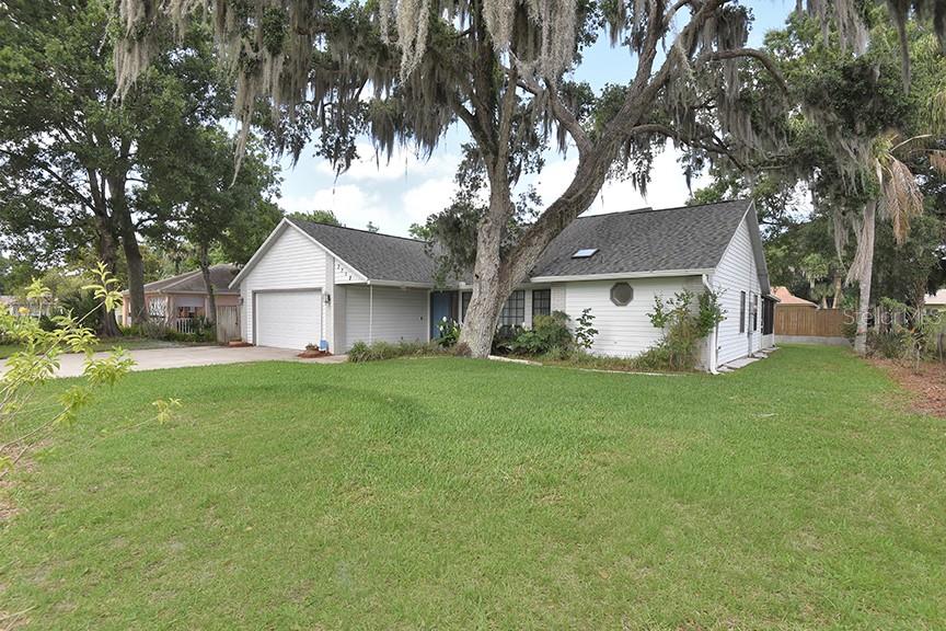 Spacious and inviting, this 4-bedroom, 3-bath home in the southern section of Florida Shores offers nearly 2,200 square feet of comfortable living space, a new roof in 2024, on nearly a quarter-acre lot. Built in 1989, the home features an open-concept floor plan with a large great room, wood-burning fireplace, skylights and a screened lanai accessible from both the great room and the private primary suite. The split-bedroom layout provides added privacy, while two of the other bedrooms share a convenient Jack-and-Jill bathroom. Fresh interior paint and a newer roof add peace of mind, and the mostly fenced backyard offers plenty of room to relax, garden, or entertain. With generous living areas and a flexible layout, this home offers exceptional value and space in a well-established neighborhood. Close to Shopping, Indian River Elementary School, Whistle Stop Park, and boat launches onto the Lagoon-the Fisherman’s Paradise! Note that this property is NOT in the Special Flood Hazard Area.