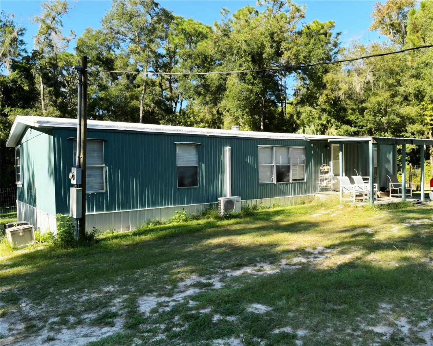 PRIVACY ! PRIVACY ! PRIVACY ! Very peaceful 3 Bedroom/ 2 Bath mobile on close to 5 acres on a Dead-end Private Street yet still conveniently located to Brooksville, Weeki Wachee and Spring Hill. This road is not used for other vehicles. These almost 5 aces are completely fenced and secured with a Cattle Gate. Two metal outbuildings are covered by 16 gauge metal cover over. New roof and Sealer for the mobile just added 2026. The new Well parts and Tank were added 2026 also. They are covered also with metal roofing. There is a new UV Light added for extra protection of Water Quality which tested great in 2024. New dirt was brought in and trees cleared for a new home to be built while living in the 1981 mobile to oversee construction. Mobile has been slightly renovated. It has all new plumbing, Sewer clean out and Septic was certified 2026. The Interior and Exterior have been painted. There has been new Vinyl Plank Flooring installed and the Bathroom Updated. The kitchen features a new sink faucet. LG light panels have been added and has a food pantry for storage. The Primary Bedroom hosts a Sunken Garden Tub and a Large Walk-In closet. This mobile has 2 AC/Heat Split Units which keep it cool all Summer Long. There is a beautiful Walking Trail that stays mowed for early mornings to watch the Birds such as Owls, Eagles, and Cardinals. There are approximately 10 - 12 Bird and Squirrel Boxes on the property for the Wildlife. It has an extended Circular Drive on the Property in front and in back a fenced Dog Run. This property can be financed so pick up this once in a lifetime gem located right here in Hernando County.