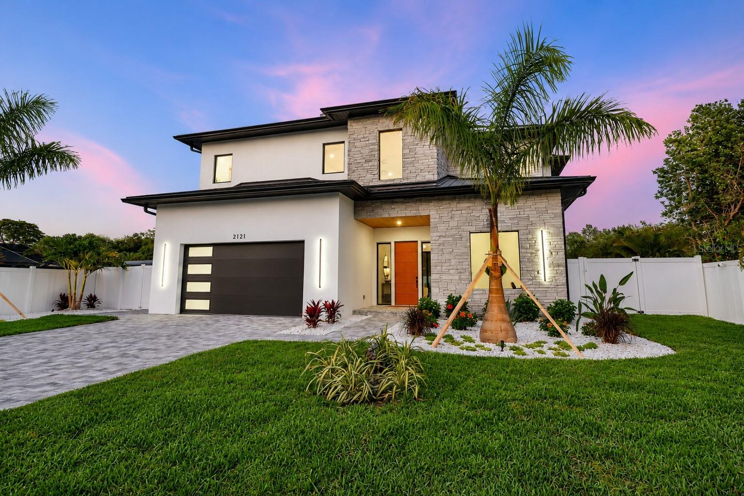 Not just another house but a carefully curated masterpiece by Segatto Property Solutions Inc. Come experience a blend of modern luxury, sophisticated design, and effortless Florida living in this stunning, newly completed custom residence. This move-in-ready, two-story block home offers four bedrooms and 4.5 baths plus an office, thoughtfully designed with impeccable attention to detail, soaring ceilings, and an open-concept layout ideal for everyday living and elevated entertaining. From the moment you enter, you’re greeted by 10-foot ceilings throughout, with dramatic 22-foot ceilings in the great room that create a grand, light-filled space. The office and primary suite also feature 12-foot ceilings, adding an extra layer of refinement and comfort. The designer kitchen is the heart of the home, showcasing quartz countertops, all Moen fixtures in bronze gold, and matte black, a premium KitchenAid appliance package, custom cabinetry, walk-in pantry, and an oversized island that flows seamlessly into the great room and dining areas. Expansive sliders open to the outdoor living space, delivering the ultimate indoor-outdoor lifestyle. Go outside to your fully fenced, private oasis featuring a heated saltwater pool, a fully equipped covered outdoor kitchen with grill and refrigerator, and an outdoor shower, ideal for entertaining or unwinding in total privacy. The first floor primary suite offers a spa-like retreat with luxurious finishes, generous space and a beautifully appointed bath, featuring dual shower heads, free-standing tub and an oversized walk-in closet. Upstairs, two additional en suites and a versatile loft area with a wet bar provide the ideal setting for a media room, lounge or guest retreat. Practicality meets luxury with a well-appointed first-floor laundry room featuring LG smart washer and dryer, additional built-in storage and a utility sink. Personalize your new home with a Builder Allowance of $50,000 to be used for your closet buildouts. Every detail of this home reflects quality craftsmanship and modern elegance, delivering the feel of a high-end model home without the wait. Ideally in Arlington Park, near shopping, dining, beaches and everything Sarasota has to offer, this exceptional home is ready for its first owners. Schedule your private showing today. Homes of this caliber, completed and move-in ready, are a rare opportunity.