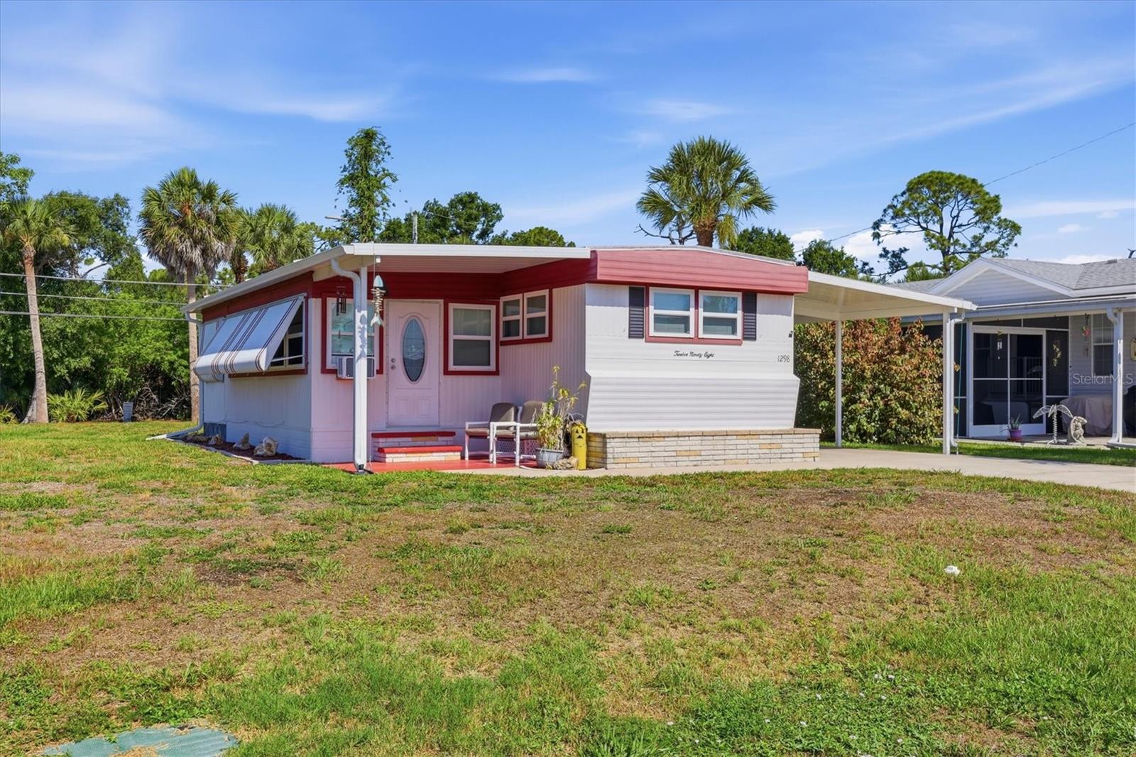 Live the Florida lifestyle in Manatee Cove, a sought-after 55+ boating community in Englewood offering a private community boat ramp with Gulf access and an optional HOA. This completely remodeled home is move-in ready and perfect as a seasonal getaway, winter retreat, investment property, or full-time residence. Major updates include a 2023 roof, 2019 A/C, 2024 water heater, double-pane windows, a new 11' x 42' carport, and a new 6' x 8' storage shed. The spacious 27' x 9' air-conditioned flex space provides additional room for entertaining, hobbies, a home office, or guest accommodations. A 10' x 8' laundry and storage shed adds extra convenience, and the refrigerator located in the shed conveys with the home. Relax in the private backyard and enjoy the peaceful setting,or launch your boat and spend the day exploring Lemon Bay, the Intracoastal Waterway, and the Gulf of Mexico. Conveniently located just minutes from Englewood Beach, historic Dearborn Street, waterfront dining, shopping, golf courses, medical facilities, and everyday conveniences, this beautifully updated home offers coastal living at its finest.