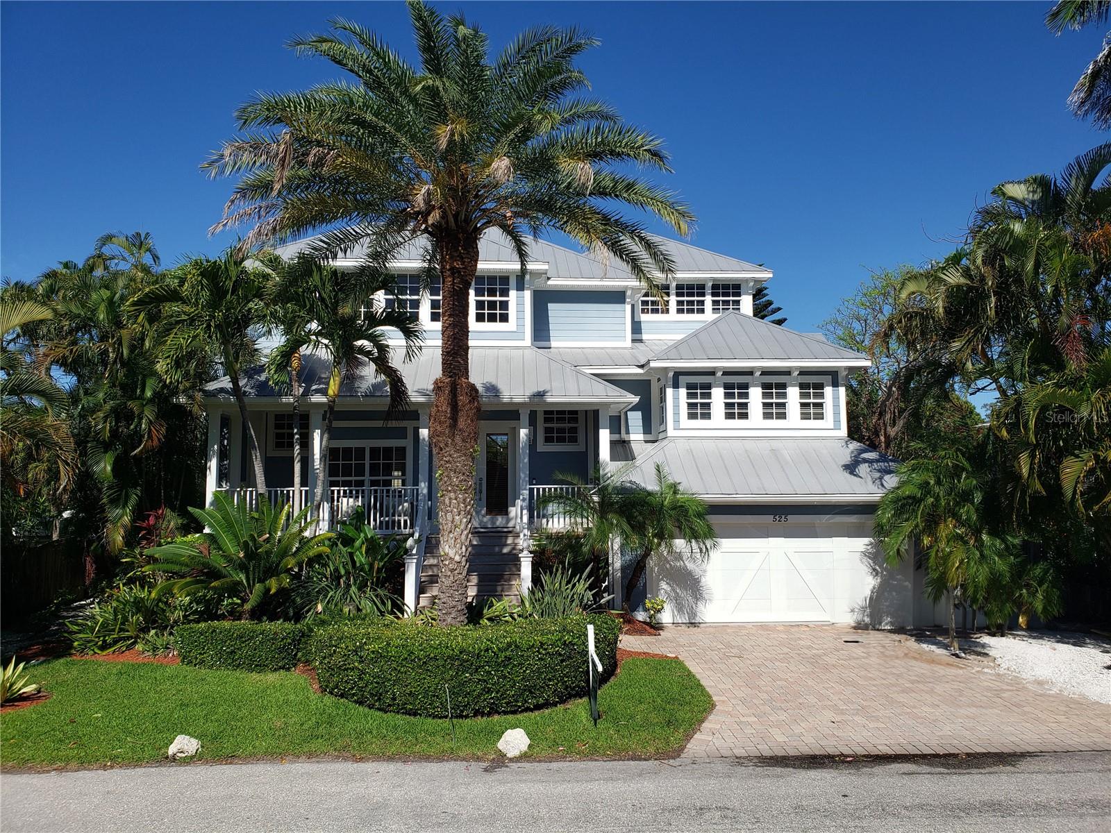Magnificent Key West-inspired waterfront home with expansive canal views. This exquisite 4-bedroom, 3 ½-bath residence boasts luxurious features such as custom-crafted architecturally detailed ceilings, intricate millwork, solid core doors, and roofed decks on all levels. The open great room layout welcomes you with style, while the well-appointed gourmet kitchen with wood cabinetry, granite and quartz countertops, a bar, warming drawer, and wine cooler is perfect for entertaining guests. The screened patio area is the ultimate outdoor oasis with heated pool, waterfall spa and tranquil views of lush landscaping and shimmering waters. Enjoy fun and adventurous excursions from your boat dock offering easy and open access to the Gulf and the Bay. Thoughtful and convenient appointments abound such as a central sound system, fire sprinkler system, central vacuum, impact-resistant windows and doors, and an emergency generator transfer switch. The property further offers a media room or optional bedroom (the room is plumbed for a bath). There is an elevator for easy accessibility, and the 4-car garage ensures ample space for your vehicles. Recent updates include new blinds and shutters in the primary bedroom; complete makeover of the primary bath and closet (with additional special shoe closet) a soaking tub, smart toilet/bidet, walk-in shower, vanity, and custom carpentry; new built-in shelving, desks, filing cabinets and blinds in the office; new dishwasher and garbage disposal in kitchen; resurfaced pool and spa and new pool enclosure screens; and an updated dock with composite decking and newly added kayak lift and 10k aluminum boat lift. Additionally, the entire HVAC system has been replaced, and the garage door is hurricane-rated. Embrace the pinnacle of waterfront living in this exceptional Key West-inspired home, where every detail has been carefully curated to create a haven of luxury.