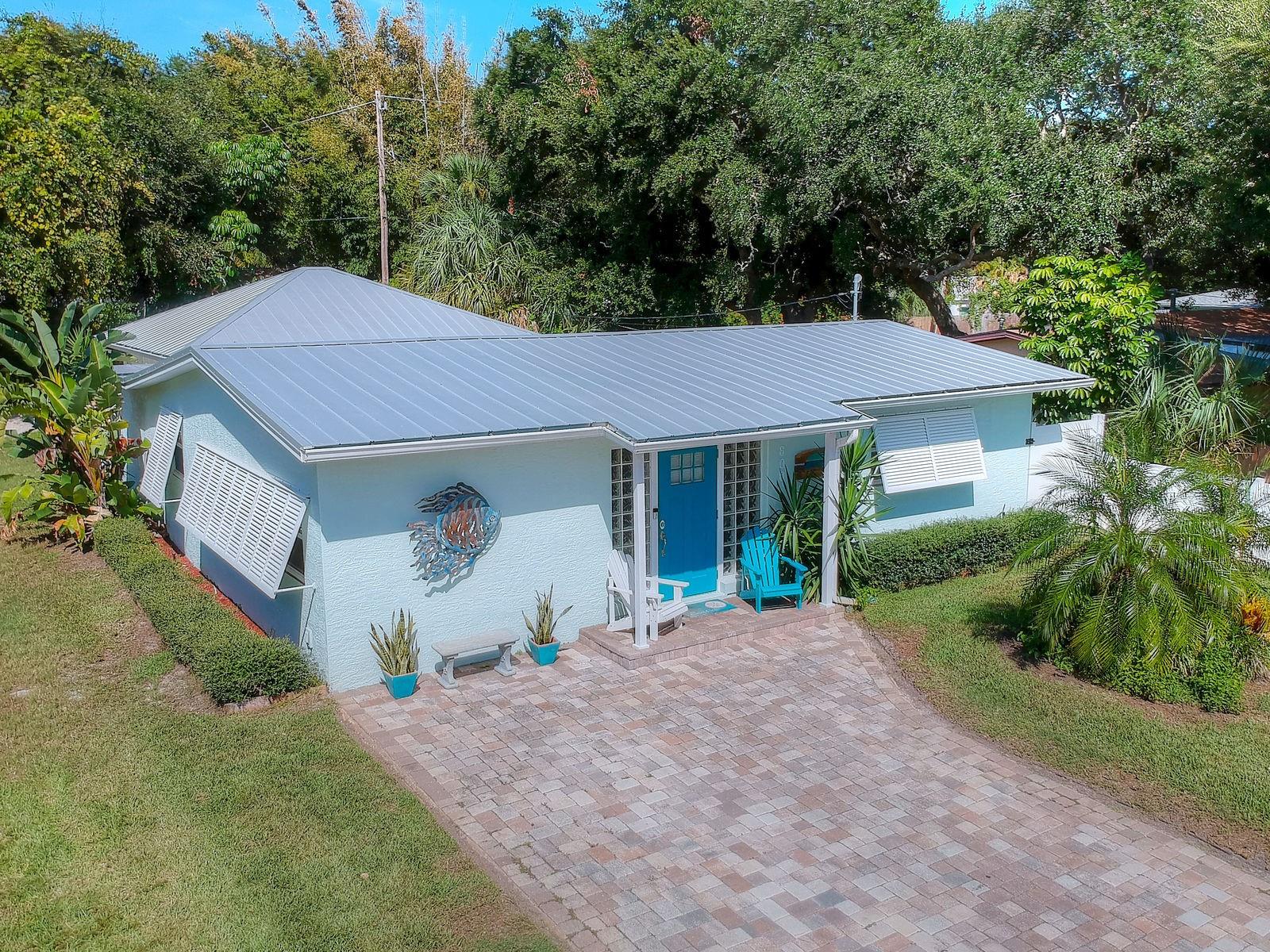 Is it time to make your dream of living at the beach a reality?  It is easy to do with this beautiful 3 bedroom/ 2 bath home just steps from the ocean.   This home was renovated in 2014 and has much to offer.  Amazing Granite Counter Tops, Tile Backsplash, Stainless Steel Appliances,  Beadboard Cabinetry and Breakfast Bar make the kitchen a must see!  The split floor plan boasts a large master bedroom with a renovated ensuite bathroom on one side and on the other, are two guest bedrooms and a renovated guest bathroom.  The design of this home, with its open-plan Kitchen, Dining and Living area, is made for entertaining family and friends.  Everyone will love hanging out in the inviting Living Room with its shiplap accent wall, unique coastal ceiling fan and plantation shutters.  In Florida, it's all about enjoying the outdoors. You will love spending time relaxing and cooking out in your courtyard surrounded by privacy fencing.  Parking and storage is not a problem as this home has a detached, 2 car garage with a separate golf cart entrance.  A neatly pavered driveway, outdoor shower, timed irrigation system, concrete block construction, storm shutters and metal roof all contribute to the desirability of this home.  One item that can not be overlooked is the LOCATION.  Upon arriving in New Smyrna Beach, one is reminded of what a beach town should be.  At the end of this street is the Atlantic Ocean!  It is an easy walk or bike ride to put your toes in the sand and soak up the sunshine.  The Canaveral National Seashore is just a few miles away.  Sightings of Dolphins, Manatees and Sea Turtles are all things that locals get to experience, not to mention rocket launches from nearby Kennedy Space Center.  Bike paths, local restaurants, kayaking/ boating, fishing, festivals and an active arts community are all a part of why people are drawn to this unique beach town and you will be too! ;Water: City
