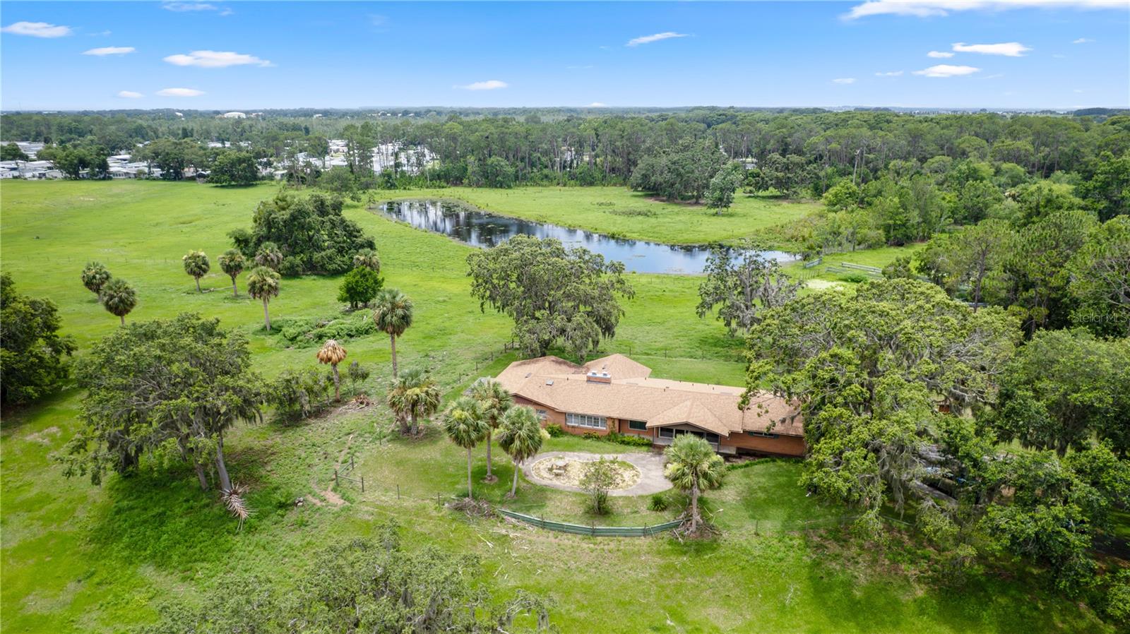 Under contract-accepting backup offers. Spectacular 42-Acre Ranch Estate in Tavares, Florida
Welcome to your dream homestead. A tree-lined gated entrance sets the tone as you approach this sprawling property of lush, fenced pastureland highlighted with majestic oaks surrounding a picturesque pond. This exceptional ranch offers everything you need for country living with comfort, functionality, and breathtaking views.

The main residence has 3 bedrooms and 3 baths. Home features vaulted ceilings accenting wide open living spaces blending modern convenience with rustic charm. Plenty of windows and glass doors allowing you to enjoy the awesome views of the estate.

This would make a fantastic family compound with the potential of multiple homesites!

Designed for the serious rancher or equestrian enthusiast, the property includes:
• A barn and equipment barn for all your tools and gear
• bunkhouse ideal for unique private space or entertainment venue
• Horse stalls, cow pens, and a roping arena ready for action
• Secure, fenced pastures for easy livestock rotation and grazing
Whether you’re looking to operate a full-time cattle or horse operation or simply enjoy the peace of rural Florida living, this property checks every box. Privacy, functionality, and natural beauty all come together in this one-of-a-kind ranch.
All of this, just minutes from shopping, dining and entertainment.
Don’t miss the opportunity to own a piece of paradise. The town of Tavares, often referred to as “America’s Seaplane City,” is a vibrant and scenic community in central Florida. Located in Lake County, Tavares offers a high quality of life, combining small-town charm with modern amenities. Here are some of the key benefits of living in This Property is in the city of Tavares which is situated on the shores of Lake Dora and part of the Harris Chain of Lakes, Tavares is a paradise for water enthusiasts. Boating, fishing, kayaking, and seaplane activities are central to the lifestyle The city boasts scenic parks, trails, and abundant opportunities to enjoy the outdoors. Tavares provides easy access to nearby cities like Orlando, Mount Dora, and Leesburg and Major attractions, such as Walt Disney World and Universal Studios, are less than an hour away. The downtown area is a hub of activity, featuring waterfront restaurants, shops, and entertainment venues. Regular events, festivals, and live music performances keep the community engaged and lively. Golf courses, hiking trails, and recreational facilities are abundant in the area
friendly community, Tavares combines the best of small-town living with the conveniences of being near major metropolitan areas