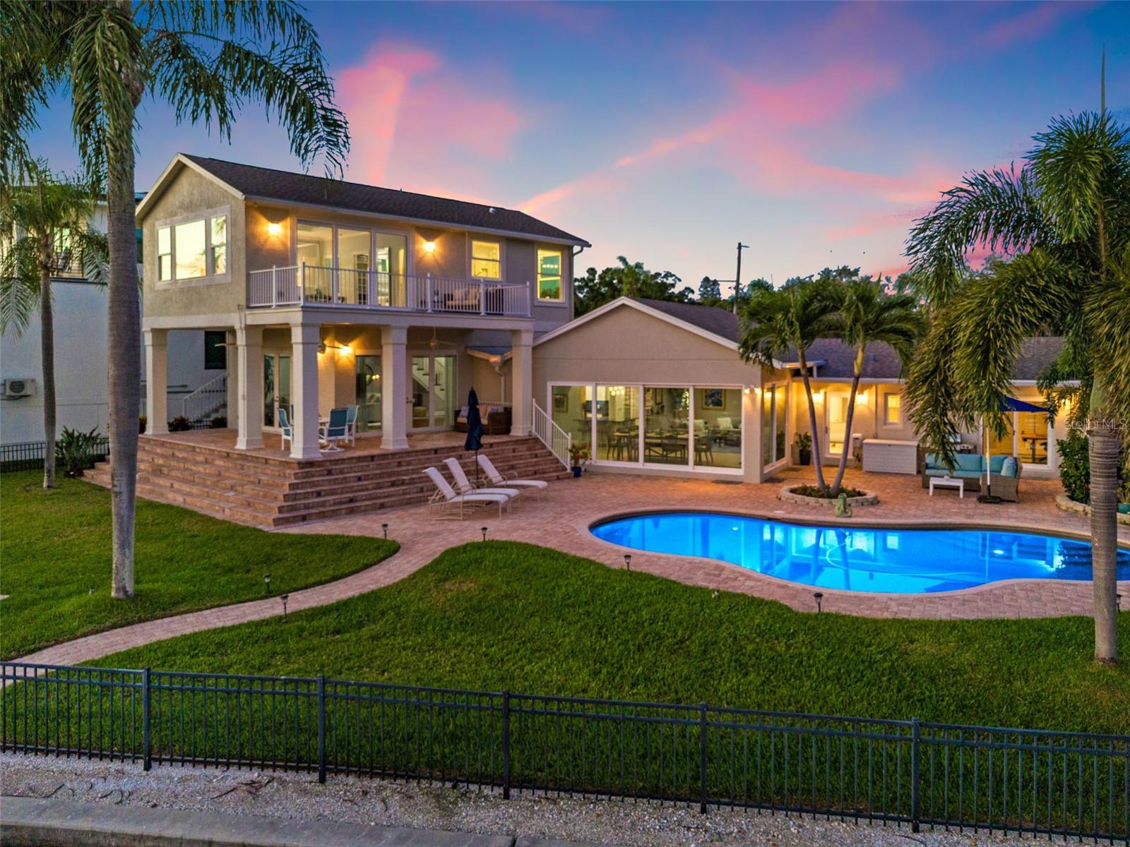 Luxurious WATERFRONT living in the heart of Northeast St Pete! This beautiful pool home is nestled along the picturesque Smacks Bayou in NE St Petersburg, offering an unparalleled lifestyle of luxury and tranquility. Boasting an impressive 144 feet of waterfront on a generously wide waterway, this residence allows you to soak in the beauty of both sunrise and sunset right from your backyard every day. 
This home underwent a 3-year TOTAL renovation/transformation with an investment of nearly 1 MILLION dollars in upgrades and high-end finishes. You will notice the attention to detail in every room. As you enter you are greeted right away with a bright open-air space and wall-to-wall glistening water views! The impact sliding doors open fully to give you that dreamy indoor/outdoor resort-style living feel. The open floor plan allows for water views from almost every room in the home. The kitchen is a chef's dream at the heart of the home with high-end finishes and appliances. There is a butler's pantry for additional storage perfect for when entertaining guests. Step up to a very spacious secondary living area that is the perfect flex space, and could be used for casual living for the family, a yoga studio, or a home office.. endless possibilities! This area also has amazing water views with sliding doors that lead to your outdoor oasis! This lot is expansive and has plenty of green space for the kids and dogs to run and play! The crown jewel of this home is the stunning and spacious 2nd-floor primary suite, featuring a private balcony that provides breathtaking panoramic water views. The spa-like en suite bath is a retreat in itself, complete with a luxurious tub, separate shower, and a spacious walk-in closet and laundry area. This sanctuary offers a perfect vantage point to unwind and savor the serenity of waterfront living. There are 3 other spacious bedrooms on the main living level with one being an en suite with water views and sliding doors to the backyard. Outdoor living at its very best in the resort-like backyard, where an inviting pool, hot tub, covered patio, and a private dock with lift await. Whether you're taking a refreshing dip in the pool, indulging in the hot tub, or setting sail from your private dock, every day feels like a vacation at home. The layout of this residence is designed for seamless entertaining, featuring two distinct living areas that provide ample space for hosting gatherings and creating cherished memories with family and friends. Situated near Crisp Park in NE St Petersburg, this home offers easy access to the vibrant downtown St Petersburg scene where you will enjoy waterfront parks, sidewalk cafes, museums, and more! Boaters will appreciate the convenience of being just minutes away from Tampa Bay by boat. Enjoy the ease of daily living with shopping options like Publix, Trader Joe's, and Whole Foods within walking distance. For those who travel frequently, Tampa International Airport (TIA) is a mere 30-minute drive away. Indulge in the epitome of waterfront living with this meticulously curated residence. Every detail has been thoughtfully considered, making this home a true gem in the heart of St Petersburg's coveted waterfront community. Welcome to a life of unparalleled luxury, comfort, convenience, and breathtaking natural beauty. You MUST SEE this home to truly appreciate everything it has to offer!