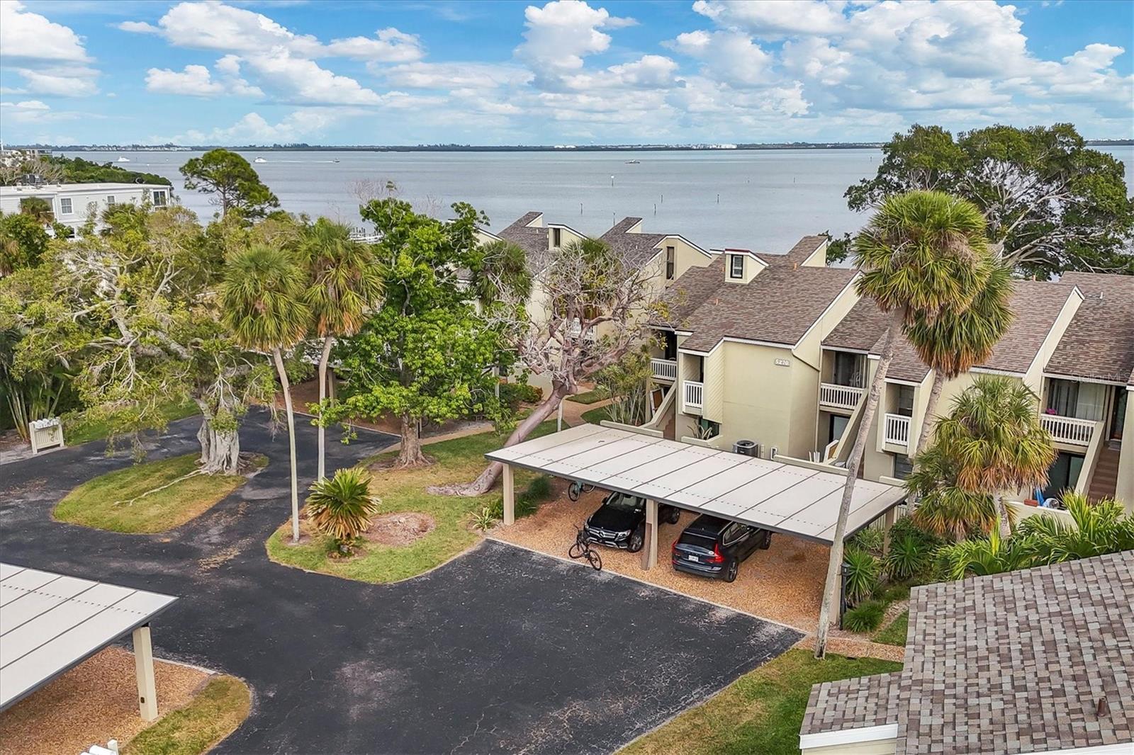 Rarely available and beautifully positioned, this 3-bedroom, 3-bath fully furnished residence with UNOBSTRUCTED FULL BAY VIEWS invites you to experience true beach-to-bay living in the coveted community of Banyan Bay on the north end of Longboat Key. From sunrise coffees on your private terrace to evenings spent watching dolphins glide across the bay, this home offers an effortless blend of comfort, coastal elegance, and unforgettable daily moments. Set within an intimate community of just 26 Bayside and 18 Gulf side residences, Banyan Bay provides a peaceful retreat with exceptional amenities. Start your mornings with a stroll along your private Gulf beach access, join neighbors for a friendly match on the tennis/pickleball court, launch a kayak directly onto the bay, or unwind by the heated pool after a day on the water. A day dock/fishing pier, fitness center, clubhouse, and convenient bicycle storage further enhance the lifestyle of this warm, social community. Inside, more than 1,400 square feet of thoughtfully designed living space showcases a spacious kitchen with granite countertops, SS appliances, and a breakfast bar and nook ideal for casual dining or gathering with friends. The open great-room layout features soaring ceilings that fill the home with natural light and frame the captivating bayfront scenery. The primary suite offers its own private terrace overlooking the shimmering water—perfect for quiet mornings or evening breezes. A guest suite on the main level ensures comfort and privacy, while a charming spiral staircase leads to a versatile loft and a spacious third bedroom suite—ideal for hosting visitors, working remotely, or enjoying a dedicated creative space. Terra cotta tile flooring throughout the first level brings warmth and coastal character, while Tommy Bahama inspired finishes make this turnkey furnished residence truly move-in-ready. Beyond the community, you’ll find yourself within walking-distance to restaurants and the Centre Shops. Durante Park and the Longboat Key Center for the Arts are just moments away, adding convenience and charm to the neighborhood. Discover the rare combination of lifestyle, location, and waterfront living that only Banyan Bay can offer—where every day feels like a coastal escape.