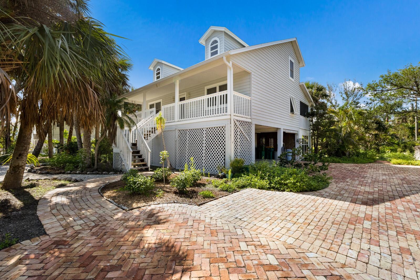 This Single-Family 3-bedroom, 2-bathroom single-family home delivers exceptional value just steps from the Gulf’s pristine beaches and unforgettable sunsets just south of the village. Situated on a spacious and secluded 100’ x 153’ lot, the property is surrounded by native landscaping, offering true privacy and tranquility. Features include a Chicago brick paver driveway, propane fireplace, dumbwaiter, and a screened lanai, ideal for relaxation and entertaining. Updates include a new A/C system (July 2025), and a newer Roof (2022), Impact Windows in (2011), making this home ready for immediate enjoyment with room to personalize and expand. Tour the island by golf cart, take peaceful walks, and enjoy nearby access to the Johann Fust Library, shops, and dining. Whether you're seeking a quiet retreat or future potential, this is one of Boca Grande’s best single-family values, private, charming, and full of opportunity.