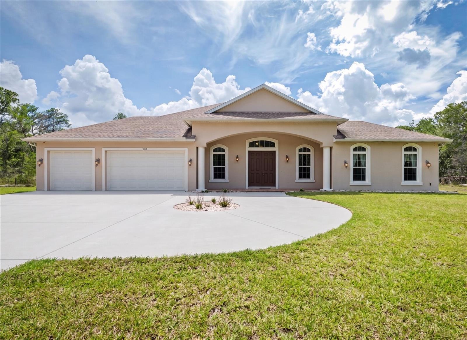 Discover your private Florida sanctuary! Tucked behind a gated entrance on 5 wooded acres, this pristine 2021 custom estate offers nearly 3,000 sq ft of modern luxury with 3 bedrooms and 3 bathrooms. The breathtaking open-concept living space is flooded with natural light and designed for effortless entertainment. At its heart is a spectacular chef’s kitchen featuring a massive center island, gorgeous shaker cabinetry, and stainless appliances, which flows seamlessly into the expansive living and formal dining areas. Retreat to the luxurious primary suite, boasting a spa-like en-suite bathroom with a deep freestanding soaking tub and an oversized glass walk-in shower.
The indoor-outdoor flow is spectacular. Step out to the expansive covered lanai—conveniently pre-plumbed for a custom summer kitchen—which overlooks a sparkling, fully screened-in private inground pool and your tranquil 5-acre backdrop.
A massive circular concrete driveway leads to an oversized 3-car garage, offering abundant parking and storage. For ultimate peace of mind, the home is pre-wired for a 360-degree security camera system and equipped with a 50-amp generator plug. Enjoy the rare combination of complete country seclusion just minutes from top-rated Port Orange schools, dining, and beaches!
