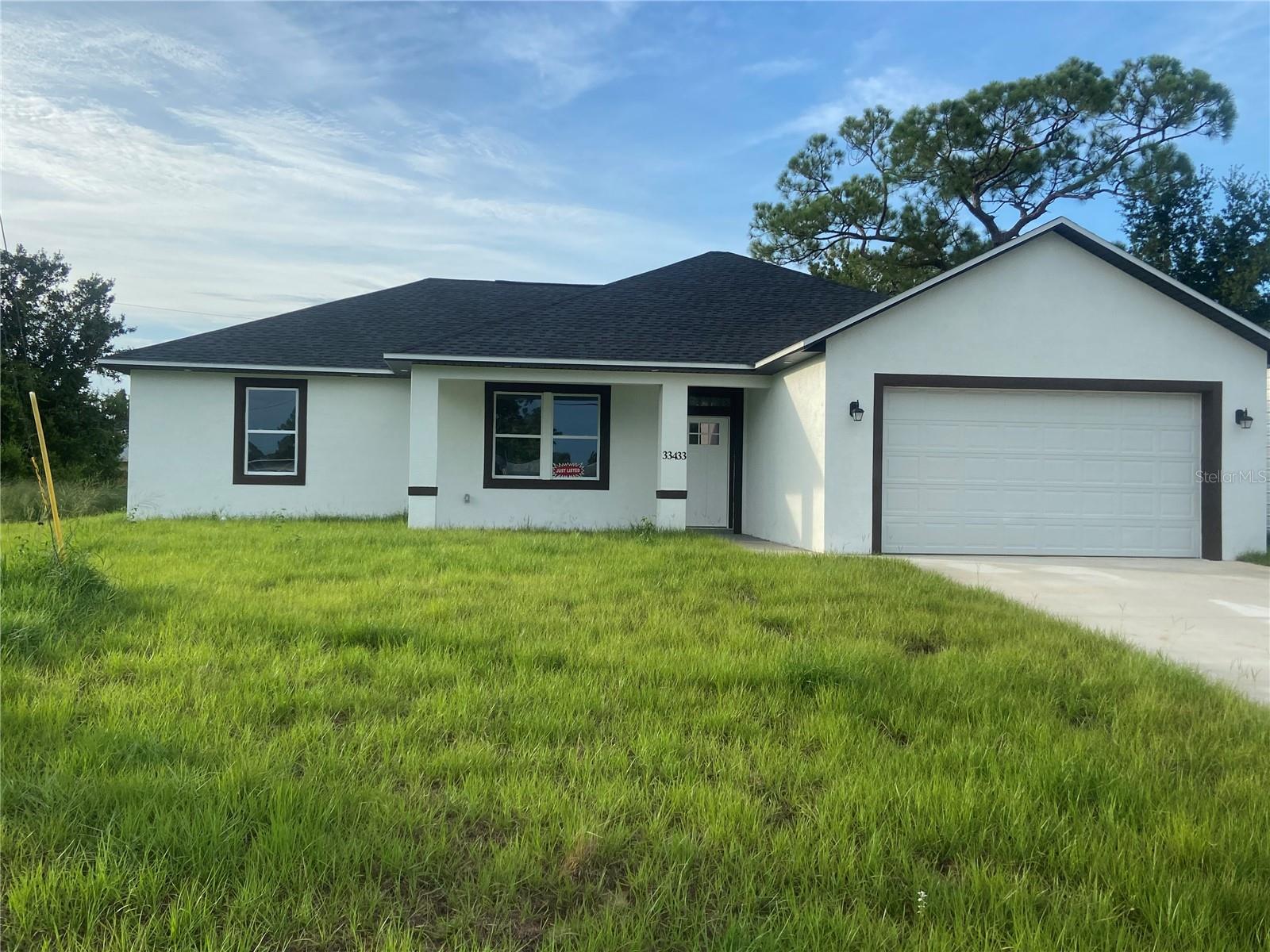 New Construction in the heart of Sebring in the desirable area of Sebring Country Estates at only $178 per sq ft. Buyer Incentive of $5000.00. Spacious open, split floor plan, 3/2/2 block home. Open concept with great room featuring a 10 foot high  tray ceiling, recessed LED lighting & prewired for ceiling fan. All other ceiling are 9 ft high. Home features,  porcelain tile throughout.  Spacious kitchen opens to great room. Kitchen features an island granite counter tops, stainless steel range, built-in microwave, dishwasher, side by side stainless refrigerator,  farm house style sink with matte  black fixtures and white wood cabinets. All drawers are soft close. Kitchen features a nice size pantry. Dining area is open to the kitchen, features black matte drop lighting and double doors to the outside. Master Suite is spacious and prewired for a ceiling fan, features an in-suite walk in closet with wire shelving. Also features an in-suite master bath with double vanities, granite counter tops, walk in tile shower & rain shower head. The other 2 bedrooms are located on the other side of the home. Bedrooms  are prewired for ceiling fans. Closet doors are bi-fold. There is a full bath in the hallway between the 2 bedrooms.  This bath has granite counter top & tiled tub/shower. This bath is roomy with plenty of room for accessories. Home has 2 inch faux wood cordless blinds. The utility room in inside the home. Home has a double garage with attic access & automatic garage door opener .This home has a covered open front porch. The yard features an irrigation system. The septic tank is in the front yard so the back yard has pool space. Large back yard.   Minutes from Walmart, Walgreens, Publix, hospitals & US Hwy 27. Sebring International Raceway is 13 miles, approximately 70 miles from Punta Gorda Airport, 80 south of Orlando International Airport, 97 miles south of Tampa International Airport , 160 miles from Miami and about 70 miles to east or west coast of Florida. Come live the dream in Sebring!