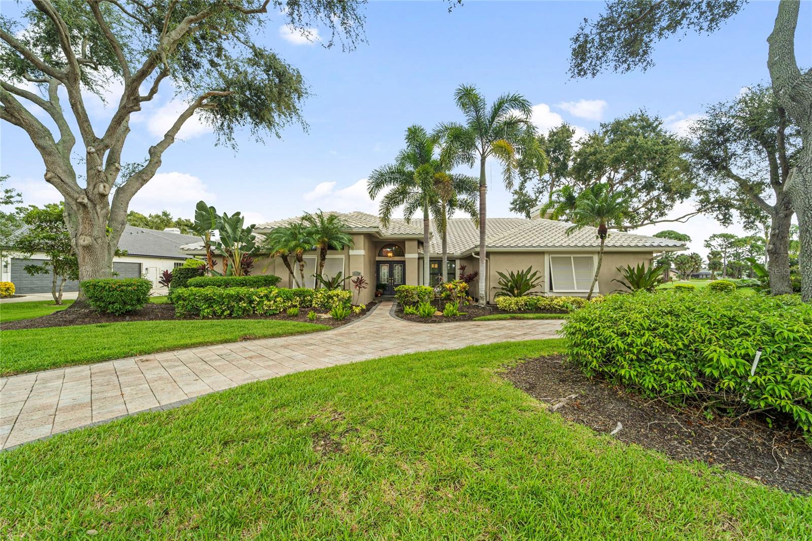Breathtaking double lake views directly on the TPC PLAYER’S course with Sunsets galore!! Experience refined Florida living in this impeccably maintained single-story residence, nestled within the prestigious gated golf club community of TPC Prestancia. Located on one of the most coveted streets in the neighborhood, this home offers unique views of two glistening lakes and the rolling hills of the golf course, all while ensuring exceptional privacy and tranquility. This property is a bird watcher’s haven! This exquisite residence features 3 spacious bedrooms, 2 bathrooms, a powder room and an office that can serve as a fourth bedroom. The open floor plan, adorned with traditional architectural elements, exudes timeless elegance. The owner's suite is thoughtfully positioned to provide a serene retreat, with two generously sized walk-in closets and direct access to the soaring lanai, stunning pool and hot tub! The guest wing is distinctly separate, ensuring privacy for all. The second bathroom, tastefully updated, serves the 2 generously sized guest bedrooms and the pool area. The kitchen, open to the family room and breakfast area, offers a warm and functional space for everyday living. It includes stainless steel appliances, granite countertops, cherrywood cabinets and a generously sized pantry. The formal dining room and living room provide ample space for sophisticated entertainment, with sliding doors that seamlessly blend indoor and outdoor living, allowing for an effortless flow between the two. Relax in the cozy family room in front of the wood burning fireplace on those rare chilly nights.  Step outside to the expansive screened lanai, where a sparkling pool and spa overlook serene lake views—creating a private oasis perfect for both entertaining and unwinding with a spacious covered area for dining "al Fresco".  Enjoy peace of mind with IMPACT WINDOWS THROUGHOUT, an annually maintained roof that is only 14 years old, dual-zone A/C systems (2015 & 2021), and an air-conditioned room in the two- cars garage that could serve as a wine cellar or extra storage. The lush landscaping spans over half an acre, enhancing the property's allure. The expansive circular driveway welcomes your guests and adds a touch of style to the front yard. Prestancia Golf and Social Club provides 24/7 gated security and is recognized as an Audubon Certified Sanctuary, with 565 acres of mature trees, wildlife, and walking paths. Tennis, pickleball courts are only minutes away! Located only 5 MILES from world-renowned SIESTA KEY BEACH!! This home blends golf course tranquility with exceptional coastal convenience. TPC Prestancia social, sports and golf memberships are AVAILABLE and optional. Schedule your showing today as this highly sought after floorplan won’t last long!! Floorplan and 3D tour available.