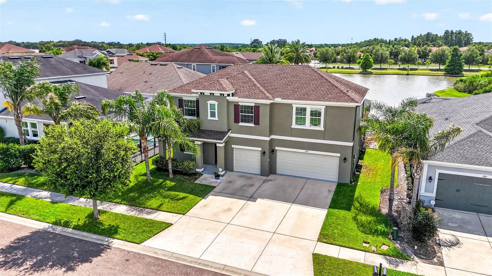 Exceptional living in Watergrass starts HERE in Cypress Bend! Bay Laurel Ct is ready for its next chapter!  5 bedrooms, 3+1 half bath, first floor primary, gorgeous water views and a private, heated pool move in ready.  Standard Pacific/CalAtlantic took architectural features from tray ceilings to arched doorways and blended it with a modern open spaces and an entertaining/ gathering floor plan.  Enter through the 3-car garage or through the glass entry front door to a bright entryway with high ceilings throughout the first floor.  Immediately to the left is an enclosed office space/ flex room. A catch-all entryway, half bath, and laundry are also easily accessible on the first floor.  Your kitchen has 42" crowned wood cabinetry, granite countertops and a break from stark white kitchens.  The island seats 4 with additional dining space in the great room.  The first floor primary suite has both soaking tub and walk in shower.  Stunning water views of the pool and pond from your window.  Upstairs is the central loft, a great work/play area and a split bedroom scheme with 2 additional full baths.  3 bedrooms to the left and 2 to the right make for plenty of room and guest space.  This is one of the most popular floor plans available in only a select few communities in Wesley Chapel.  Step outside to your outdoor retreat with privacy curtains on each side, a fire pit space, lounge area, outdoor kitchen space with dining and the heated, salt water pool facing out to the unobstructed water views.  No homes behind you! Watergrass is a premiere resort-amenities style community with optimal growth happening all around in retail, medical, and new opportunities for you.  Swig, Publix, Starbucks, ChickFilA, Chase Bank, Florida Medical, are just a few of the immediate features of this community in addition to the three community pools, clubhouse with fitness center, tennis, and pickleball.  There is none left wanting in this community & we welcome you to join us here in Watergrass!