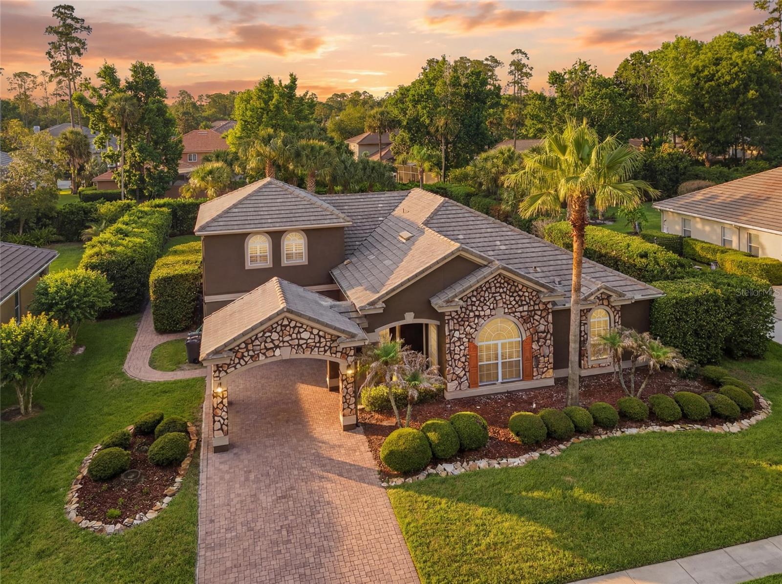Experience luxury resort-style living in the heart of Lake Mary. Situated in the most desirable community of Heathrow, this impressive residence offers the perfect combination of space, comfort, and entertainment. Featuring 6 bedrooms, 2 bathrooms, and a 2-car garage, this expansive home includes flexible living spaces designed to accommodate today’s lifestyle. One of the bedrooms has been transformed into a fully equipped private fitness room, complete with a full weight set, treadmill, and additional workout equipment — creating the ultimate in-home gym experience without ever leaving the house. Inside, you’ll find spacious living and entertaining areas filled with natural light and an inviting layout ideal for both everyday living and hosting guests. Step outside into your own private tropical retreat featuring: Resort-style grotto pool Exciting waterslide Outdoor fire pit Expansive patio and lounge areas Beautifully landscaped backyard designed for entertaining Additional highlights include: Large primary suite with spa-inspired bathroom Multiple flex spaces for office, media, or recreation Excellent indoor/outdoor flow Mature landscaping and exceptional curb appeal Privately Gated and 24 hour security monitored community Located minutes from top-rated Seminole County schools, premier shopping, dining, entertainment, and major highways, this home offers both luxury and convenience in one of Central Florida’s most sought-after locations. This is more than a home — it’s a private lifestyle retreat designed for entertaining, wellness, and unforgettable memories.