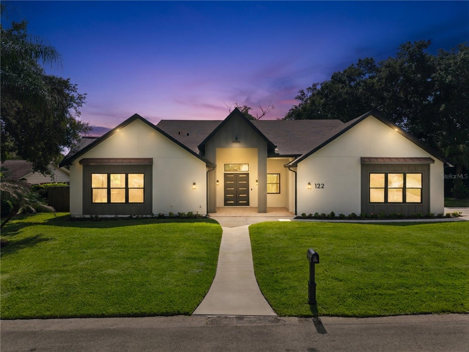Virtually Staged. Welcome to 122 Variety Tree Circle! An extraordinary custom residence where timeless architecture, impeccable craftsmanship, and modern luxury come together in one of Altamonte Springs’ most desirable communities. Completed in 2026 and situated on a beautifully landscaped 0.43-acre homesite in Spring Valley, this exceptional 6-bedroom, 4 full bathroom home offers 3,536 square feet of perfectly designed living space, combining high-end finishes, remarkable energy efficiency, and an ideal floor plan for everyday living and entertaining.
From the moment you arrive, the striking curb appeal sets the tone with clean architectural lines, a welcoming covered entry, copper accent roofs, an oversized side-entry garage, and an expansive driveway. Inside, soaring ceilings, engineered hardwood flooring, abundant natural light, and an open-concept design create an impressive first impression while maintaining a warm, inviting atmosphere.
At the heart of the home is a stunning chef’s kitchen featuring custom cabinetry, Taj Mahal quartz countertops, an oversized center island, double wall ovens, stainless steel appliances, abundant storage, and an effortless connection to the spacious family and dining areas. Expansive glass doors seamlessly extend the living space outdoors, creating the perfect setting for entertaining or relaxing with family and friends.
The private primary suite offers a true retreat with generous proportions, beautiful backyard views, and a rare wood-burning fireplace that adds warmth and character. The spa-inspired primary bathroom features dual vanities, a freestanding soaking tub, an oversized walk-in shower, and custom cabinetry designed for both luxury and functionality. Five additional bedrooms provide exceptional flexibility for family, guests, or a dedicated home office.
The backyard is equally impressive, offering the feel of a private resort. The expansive covered lanai showcases a vaulted tongue-and-groove wood ceiling with exposed timber accents overlooking the beautifully resurfaced and oversized pool, complete with a premium mini pebble finish, new skimmers, new filtration equipment, a new pump, and LED lighting. The fully fenced backyard provides ample green space beyond the pool for recreation, pets, or future outdoor enhancements.
Beyond its beautiful finishes, this home was built with quality and longevity in mind. The entire plumbing system has durable PVC plumbing, the home features custom-built energy-efficient windows, spray foam insulation throughout, two brand new high-efficiency HVAC systems, the garage is wired for an EV charger, solid-core interior doors, engineered hardwood flooring, porcelain tile and an oversized walkable attic offering exceptional storage rarely found in today’s homes.
Residents also have the option to join the Optional Spring Valley HOA, providing access to outstanding community amenities including a private boat launch, fishing dock, four-acre waterfront park, tennis and pickleball courts, basketball courts, volleyball courts, handball courts, playgrounds, and open green space.
This is far more than a new home! It’s an opportunity to own a thoughtfully crafted custom residence where exceptional design, premium construction, and everyday comfort come together in one remarkable property.