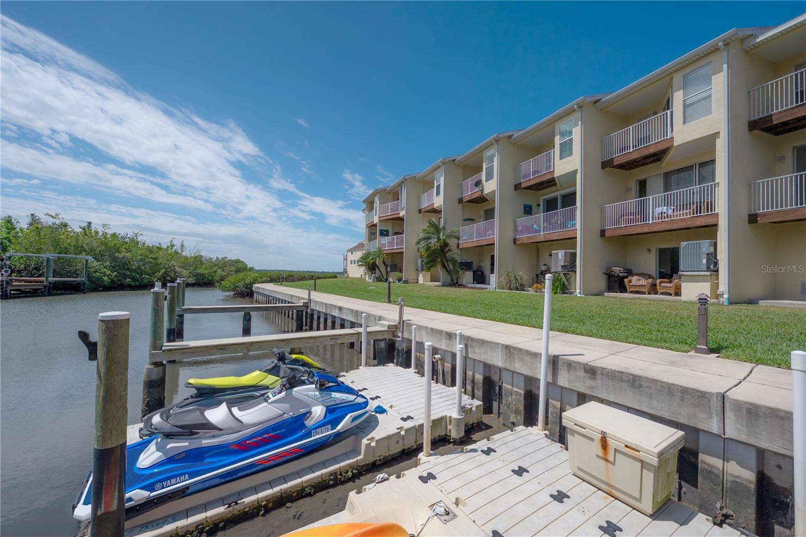 Are you dreaming of your own stylish urban OASIS surrounded by nature yet minutes from everywhere you want to be? Experience effortless coastal living in this exceptional waterfront townhome, perfectly designed for those who appreciate space, light and direct access to the water. Featuring two private boat slips, this residence offers a RARE opportunity to keep your vessels close and enjoy days on the water at a moment's notice. Inside, the home unfolds into an open, light-filled floor plan enhanced by soaring high ceilings and expansive windows that invite natural light throughout the day. The seemless flow between living, dining, and kitchen spaces creates an ideal setting for both RELAXED everyday LIVING and entertaining. Water views provide a constantly changing backdrop, adding a sense of CALM and CONNECTION to the outdoors. The generous layout offers flexibility for hosting family and guests, while the airy ceiling heights add architectural drama and a sense of openness rarely found in townhome living. Whether you're enjoying quiet mornings with coffee by the water or gathering with friends after a day on the boat, this home adapts effortlessly to your lifestyle. Outdoor living is just as compelling, with immediate access to the waterfront and your own boat slips just steps away - perfect for boating, paddleboarding, or sunset cruises. This is a home that blends convenience and luxury, offering the maintenance ease of a townhome with the experience of a private gated waterfront retreat. Ideally suited as a primary residence or a refined second home, this property delivers the best of waterfront living - space, light, and direct access to the water- all in one elegant package.