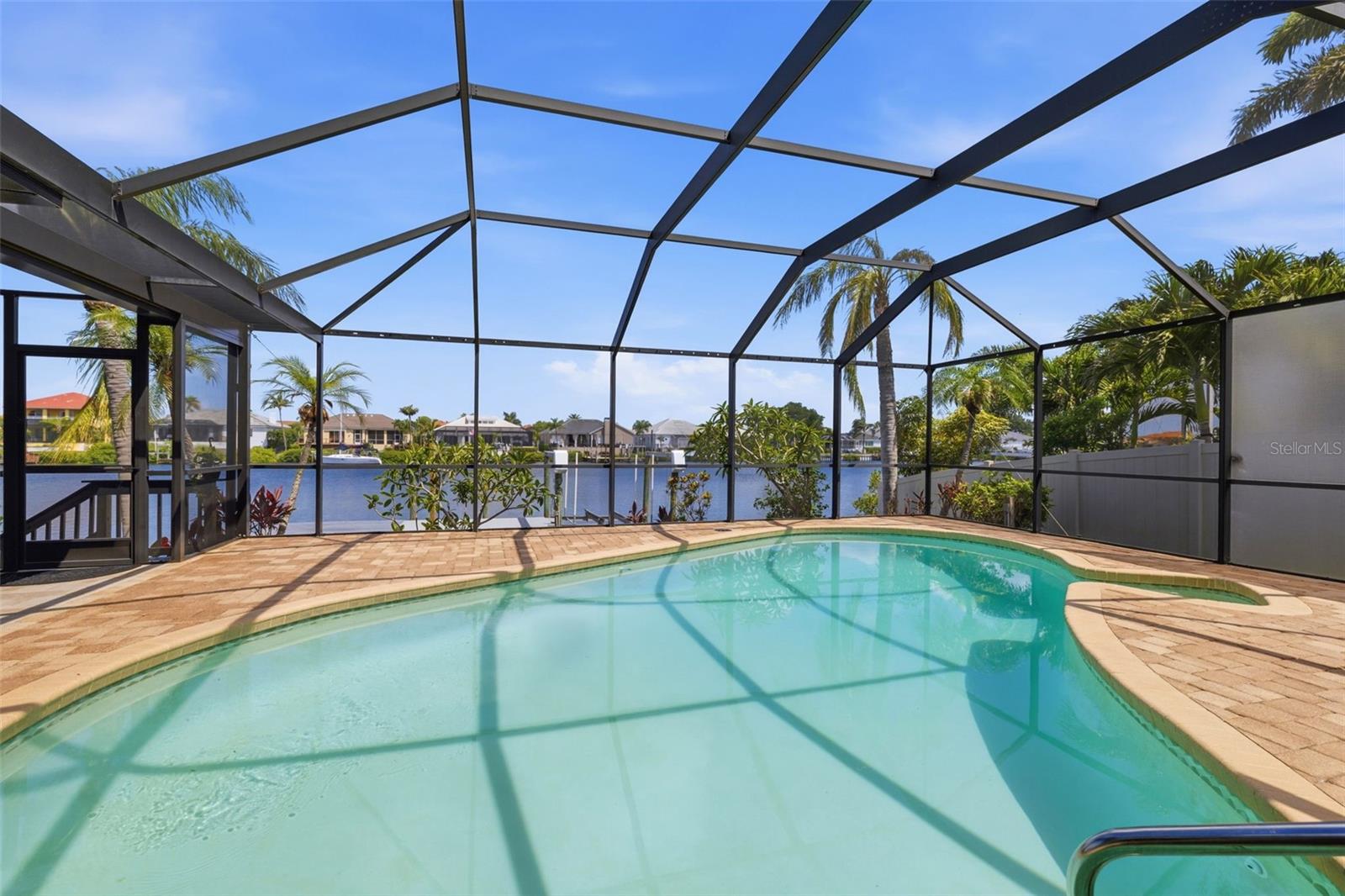 Open Water Royal Canal home on desired Chipaway Dr! Large Private View of one the widest Canals in Apollo Beach! Upgraded with Newly Designed Floor Plan! New Clay Tile Roof 2025, New TPA Roof, Newer High-End TRANE AC w/Clean Effects Filter System 2022! Kitchen redesigned & Upgraded to include all wood cabinetry, Pull Outs in all Cabinets with soft close! Newer Waterproof Luxury Vinyl Flooring throughout! This Floor plan is simply nowhere else! Entry Covered Porch with DeGeorge Wood Ceiling & Double Energy Efficient Etched Glass Doors! You see the water as soon as you enter the home! The Kitchen is upgraded fully with 42” Cabinetry, Crown Molding, Decorative Ends everywhere, pull-outs in all cabinets, Dual Pull Out Spice or Tray Drawers! Stainless Appliances with Double Oven, Built-in Drawer Microwave, fully Functioning Cabinets under Center Island, LED Lighting Throughout as needed! The Pass-Through Service Window that pockets & Quartz Bar to pass through is a coveted Feature! Bar area is fully outfitted to support entertaining with Bar Refrigerator, under-counter lighting, cabinetry with pull-out shelves + soft close! Great Room has a wood-burning fireplace for your delight! Adorned in Travertine tile! LED lighting to help you create the lighting you need when you need it! Primary Bedroom is split from Bedroom 2 and 3! Door to enclose Primary Suite with Linen Closet, Walk-in Closet with pocket door and outlets in closet! Large Primary handles a King bed with ease! Sliders out to Hot Tub & Pool! LED Lighting! Ensuite Bathroom adorned in Marble flooring with zero Entry Shower, Frameless Glass Enclosure, Rain Shower System w/Hand Held sprayer, 2 Niches for your items, Travertine Tile on Walls, and yes it is big! Dual Sinks with decorative Cabinetry Trim & Fogless Back Lit Mirrors! Water Closet has a door w/Upgraded Dual Flush Toilets to keep them clean! Plumbed and an outlet for a Bidet Toilet Seat!  4th Bedroom/Office is next to Primary with Closet, LED lighting, Sliding Glass Door to gaze at the water! Bedrooms 3 and 4 are on their own wing with a Pocket door to provide privacy, Guest Bathroom upgraded to include Dual Sinks, Quartz Counters, New Deep Tub with upgraded tile w/ Niche accent!  Bedroom 3 and 4 both look out to the Water! Laundry Closet in hallway between bedrooms with Barn Door to make it go away! Bedroom 4 also looks out to Pool! Both Rooms have Ceiling Fan Light switch controls to make life easier! 
Pool area is stunning with upgraded No Seeum Screening throughout, Wood Ceiling, Pavers that were just cleaned and sealed, Hot Tub fully functional with new cover on the way! Florida Glass Screen for privacy! Plenty of outdoor Entertainment space! Additional Screen room with Vaulted Ceilings, 6’ Ceiling Fan, Tile Floor and ready for your thoughts! Dock has a 10,000-pound lift, with Composite Marine Boards, Electrical, Dock Light, Water, and ready for a boat on the lift or sailboat! Garage is brand new with all drywall texturing and painting new, New Epoxy Floor, Hybrid Hot Water Heater has AC cold air output! Culligan Water Softener! Large Sink w/Quartz Counters, cabinetry and Drawers to make the Garage a showpiece!  New Landscaping to include Sprinkler System! Fully Fenced 6’ with Gates at both entries in upgraded Beige Color! Insulation in Attic just upgraded to R38! Amazing community where neighbors care about each other! Check out the Virtual Tour Matterport where you can literally walk through the house!