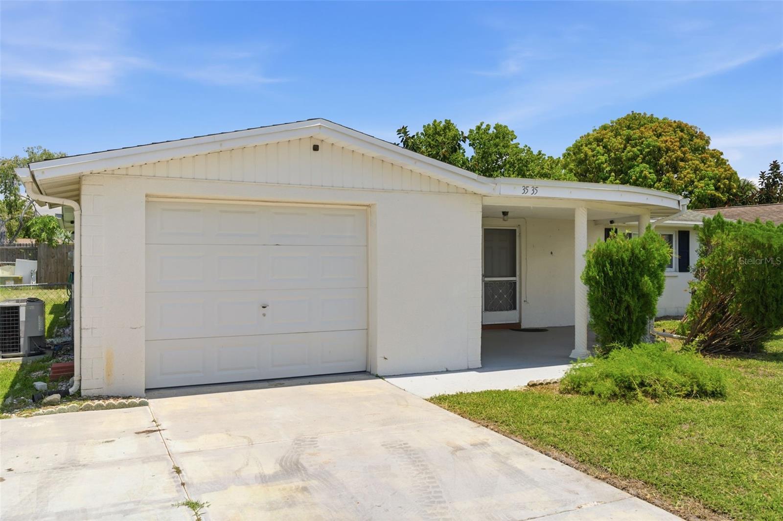 PRICED UNDER MARKET VALUE! 2-bedroom, 2 bath, almost 1100 square foot home with an attached one-car garage and screened lanai is perfect for someone that wants to buy a home under market value, have instant equity, and personalize it to their own specific taste. The functional floor plan offers comfortable living space, abundant natural light, and endless possibilities for updating. The separate dining area can easily be converted to a 3rd bedroom and the garage bath door could easily be moved to enter from the interior of the home.  Fully fenced, spacious backyard and concrete patio has are great relax, entertain, or garden. Conveniently located near shopping, restaurants, medical facilities, parks, and Gulf beaches. Whether you're looking for a primary residence, seasonal retreat, or investment property, this home is worth a look.