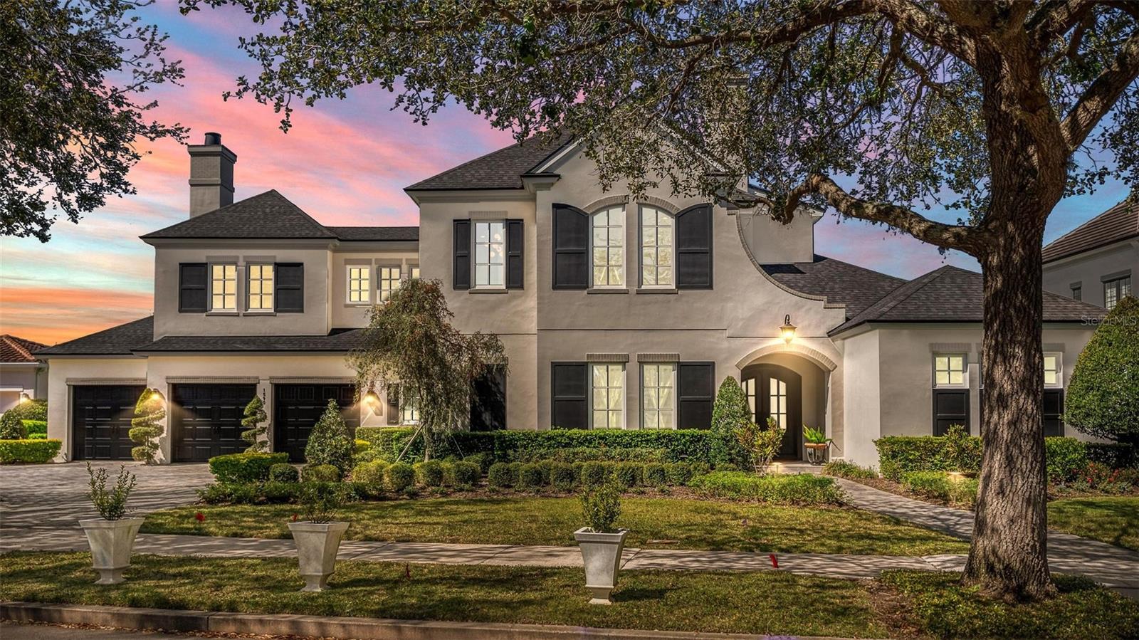 Custom-built by Dave Cahill Homes, this Baldwin Estate Sanctuary offers ultimate backyard privacy and scenic nature walks! Situated on an oversized lot with a spacious 3-car garage and brick-paved driveway, this “French Contemporary” home is open, airy, and filled with natural light.
The residence features 5 spacious bedrooms, 5 bathrooms, and a convenient pool bath. The Gourmet Chef’s Kitchen is perfectly balanced with prep space, stainless steel appliances, custom cabinetry, and quartz countertops. The Master Suite includes an oversized closet with custom built-ins, a freestanding tub, and a grand walk-in shower. The downstairs Guest/In-Law Suite boasts sunset views, extra-wide doorways, a large walk-in closet, a bathroom with a morning bar, and a private entrance.
The Den/Office is enclosed with glass pocket doors, while the Family Dining Room and Great Room feature a gas fireplace and ceiling beams. Upstairs, you’ll find 3 large bedrooms with en-suite bathrooms, walk-in closets, a game room, and abundant storage.
The covered lanai provides a fantastic entertaining area complete with a Gas DCS Grill and custom cypress cabinets, leading out to a spacious backyard with a pool for enjoying afternoon sunsets. Additional carpeted, walk-in storage is available at floor level.
Right outside, two bike and walking paths surround the lake, perfect for family outings and exercise. Enjoy a short walk to downtown Baldwin Park Village, Publix, AdventHealth Hospital, shopping, dining, and Park Avenue. Top-rated schools!