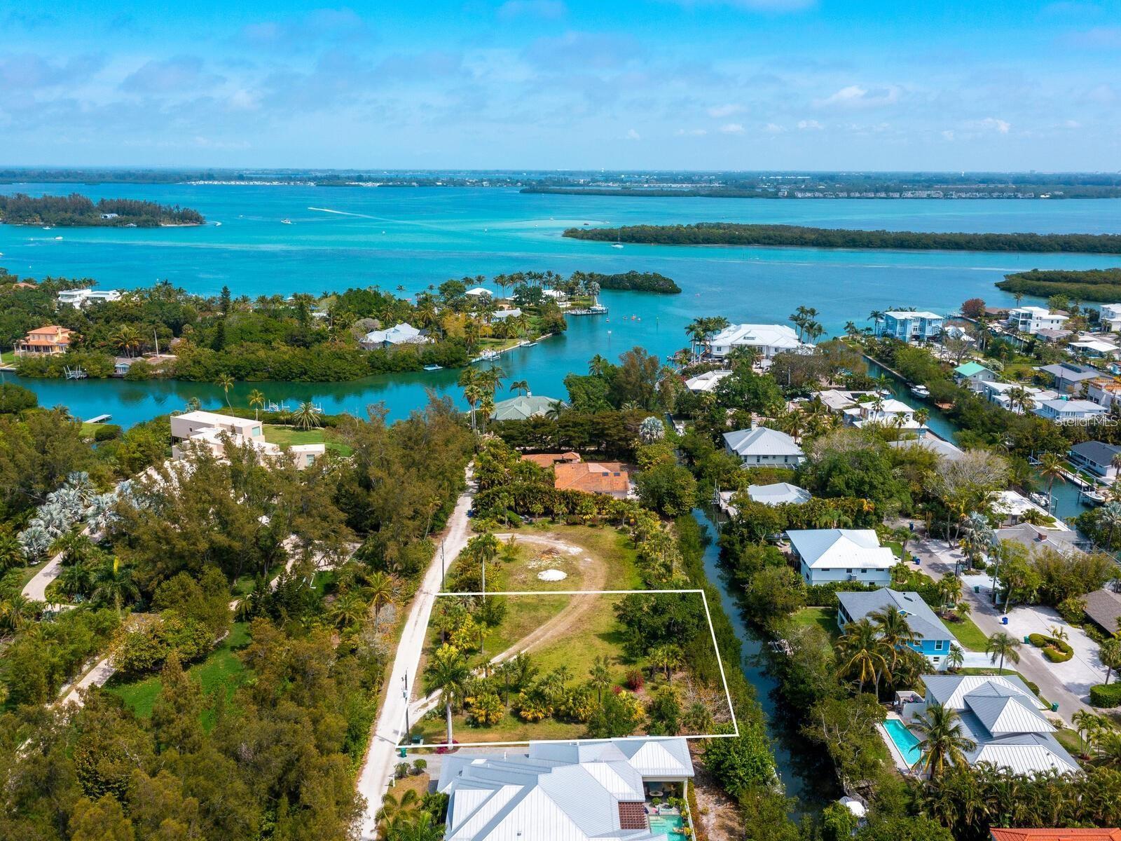 Privacy is key for this sprawling, estate-size lot tucked down a quiet street on the north end of Longboat Key. While addressed on Gulf of Mexico Drive, the property is uniquely positioned off the main roadway, set back beyond two estate-sized parcels, offering a tranquil, quiet and peaceful canal-front setting. This rare location offers one of the largest single-family home lots available on Longboat Key and provides a blank canvas to build your dream home. With the additional purchase of the adjacent lot at 6608 Gulf of Mexico Drive, nearly one acre of land can be assembled, creating the ultimate family estate and a rare opportunity in this area. Featuring approximately 140 feet of canal frontage with access to Sarasota Bay and the Intracoastal Waterway, this sought-after location invites you to fully immerse yourself in the island lifestyle. Enjoy deeded beach access just across the street, where white sand beaches and sparkling waters of the Gulf of Mexico await. Ideally just a short drive from the shopping and dining of St. Armands Circle, along with golf, tennis, boating, Holmes Beach, Anna Maria Island, and all the Sarasota–Bradenton area has to offer, you really can have it all.