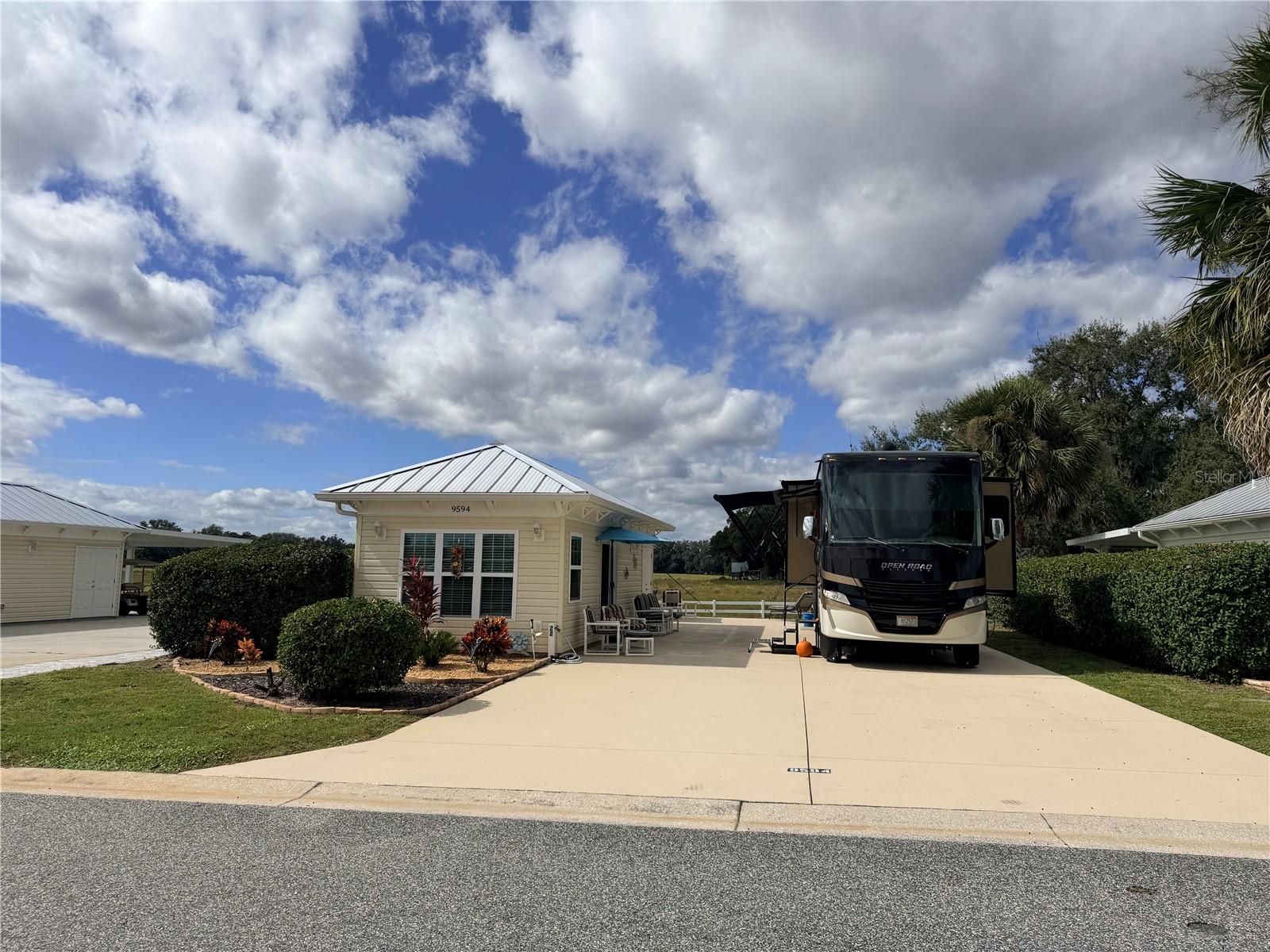 Welcome to Lot 22 in Florida Grande Motor Coach Resort, a premier Class A and Super C 
motorcoach community offering luxury, comfort, and connection. This 5,076 sq ft back-in, 
east-facing property overlooks a peaceful cow pasture, providing relaxing rural views and 
unforgettable Florida sunsets right from your patio. 
The 26' x 76' concrete pad includes full hookups for your motorhome, and the 3-year-old 
Grande Suite adds the perfect balance of extra living space and modern style. Inside, you’ll find 
tile flooring, a mini-split air system, and an L-shaped kitchenette featuring white cabinetry 
and solid-surface countertops. The full bath includes a walk-in shower, and the back storage 
area offers washer/dryer hookups and additional storage. A poured concrete patio behind the 
Grande Suite is ideal for relaxing, watching the cows, and soaking in those glowing Florida 
evenings. 
Just a short walk to the 20,000 sq ft clubhouse and pool, you’ll love the resort’s vibrant and 
welcoming atmosphere. The winter calendar is filled with activities, from pickleball 
tournaments and yoga to social events and card nights — keeping you as busy as you’d like to 
be. 
Perfectly located in Central Florida, Florida Grande offers easy access for day trips — just one 
hour to Tampa, Orlando, or Ocala, one hour to Gulf Coast beaches, and 90 minutes to the 
Atlantic. 
Known as Florida’s friendliest motorcoach resort, Florida Grande features a new pickleball 
complex, resurfaced pool, dog park, fitness room, billiards room, craft room, library, and 
so much more. 
HOA dues are $995/quarter, covering water, sewer, trash, irrigation, mowing, trimming of 
boundary hedges, and full access to all resort amenities. 
Experience the best of the Florida lifestyle in a warm, welcoming community of travelers who 
love where they live — Florida Grande Motor Coach Resort.
