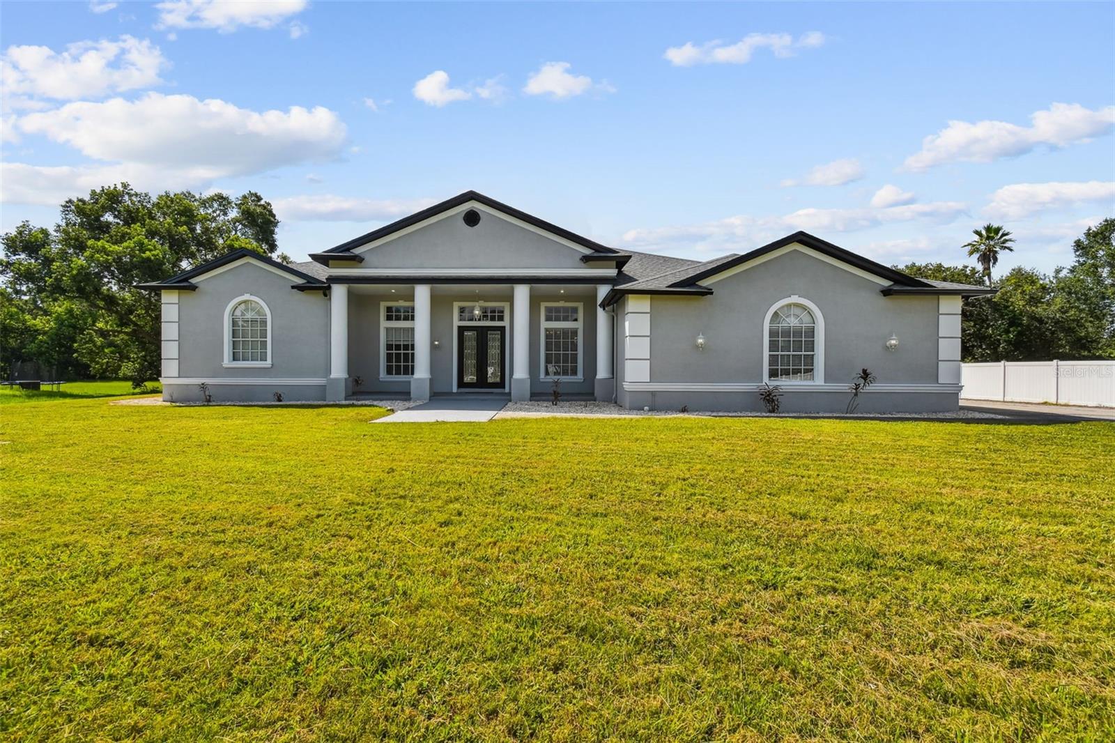 **Check Out The 3D Virtual Tour**  
*CURRENTLY LEASED TO END OF 2026*
Welcome to your Newly Renovated 3+ Bedroom / 3.5 Bath Custom Built Waterfront dream home. A masterpiece of design and craftsmanship nestled in a prestigious location. Spanning an impressive 3,578 square feet, this property is designed to cater to the eclectic tastes of modern-day homeowners, offering both the tranquility of a private retreat and the perfect backdrop for sophisticated entertaining.  It is a beacon of elegance and comfort seamlessly blended to create an unparalleled living experience. 
As you step through the elegant double glass doors, the formal foyer welcomes you into a realm of refined beauty, setting the stage for the delights that lie beyond. The formal living room, with its poised ambiance, is ideal for hosting distinguished guests. In contrast, the expansive family room becomes the heart of the home—a place where families can gather and create memories. The room's telescoping sliders open seamlessly to a screened lanai that hosts a remarkable 12-person spa, marrying indoor luxury with outdoor serenity.
The chef-inspired kitchen is nothing short of a culinary paradise, boasting 28 solid wood cabinets that provide ample storage space. Stainless steel appliances gleam under recessed lighting, enhancing the joy of cooking. A separate island with a prep sink and breakfast bar allows for casual dining or effortless entertaining.  Adjacently complimented by built-in bench seating dining area boasting panoramic windows for meals served with a view.
Retreat to the master suite, a haven within this splendid home, featuring direct lanai access for private enjoyment of early morning or late-night serenity. Walk-in closets and a storm room/safe room provide peace of mind and convenience. The en-suite master bath offers an oasis-like atmosphere with dual sink areas and a sumptuous tub beside a walk-in shower for ultimate relaxation.
Two additional bedrooms ensure comfort for family or guests alike, each with spacious bathrooms and walk-in closets. Beyond these personal quarters, this home features practical amenities such as a laundry room equipped with built-in cabinets and utility sink; an oversized 3+ car garage with workshop space; and architectural details like high ceilings adorned with crown molding, plantation blinds, custom window inserts, decorative columns that enrich its aesthetic appeal. Oversized driveway capable of accommodating multiple vehicles—underscoring its readiness to host gatherings large or small.
Take a stroll down your own private sidewalk to enjoy some fishing in the Pond.  With NO HOA, NO CDD, & No Deed Restrictions you can bring all your Boat, RV, & Toys.
Nestled in the coveted locale of Country Club Road in Wesley Chapel, this residence stands as a testament to luxurious living where every detail is curated to foster an atmosphere of both grandeur and warmth. With its thoughtful design and opulent amenities set against the canvas of its desirable setting, this home invites you to embrace a lifestyle where comfort meets elegance in perfect harmony.
Check Out The 3D Virtual Tour!