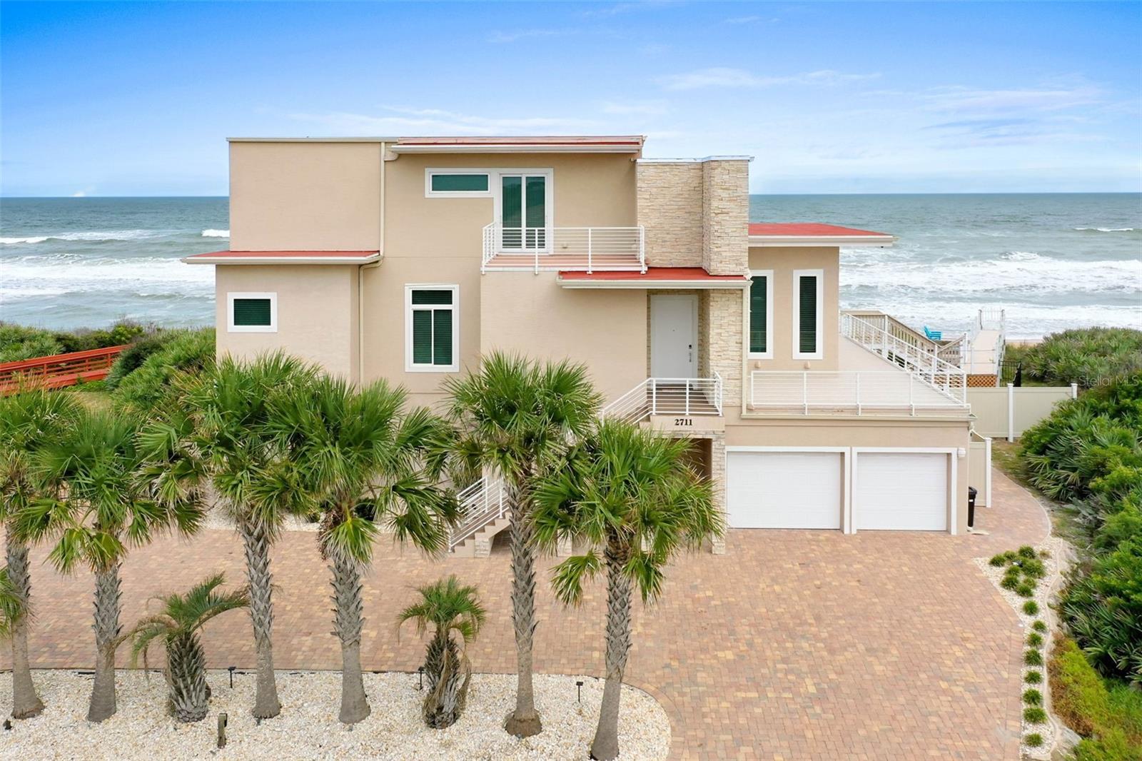 PRICE ENHANCEMENT!! This MASTERPIECE of a home is what dreams are made of - an OCEANFRONT ESTATE with Million Dollar views from every space and custom features throughout! Flaunting 3 bedrooms, 3.5 bathrooms spanning 3 stories with several balconies with updated floors, high-end fixtures, an elevator, private pool, spa and NEWLY fenced in backyard, 3 NEW AC SYSTEMS, WATER FILTRATION SYSTEM, A NEW 70 TON WATER HEATER, walls of tinted windows for UV Protection, an electric fireplace, a custom staircase, Miami Dade rated pilings and a PRIVATE BEACH WALKOVER! The kitchen features custom European cabinets, exotic granite countertops, stainless steel appliances including a wine cooler and beautiful backsplash tile. This amazing home is located on the Northern Flagler Beach that offers over 19 miles of pristine shoreline with plenty of room for sports, surfing, fishing and leisurely strolls! Schedule your exclusive showing today for this landmark home! ADDITIONAL ATTRACTIONS NEAR BY- ST. AUGUSTINE 20 MINS, MARINELAND 7 MINS, DAYTONA BEACH 35 MINS, DISNEY WORLD 1.5 HOURS, OCALA NATIONAL PARK 1.5, NEW MARGARITA HOTEL 10 MINS, HAMMOCK BEACH RESORT 5 MINS AND MUCH MORE... "GREAT LOCATION"