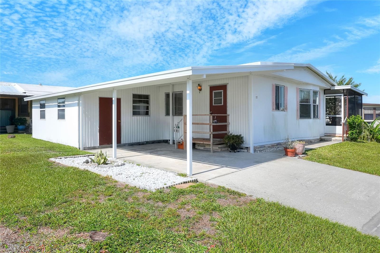 Welcome to your Central Florida retreat in Bartow’s premier 55+ Floral Lakes community! This efficient 2-bedroom, 2-bathroom manufactured home offers the ultimate perk of land ownership, meaning you own your land with absolutely no lot rent and low monthly HOA fees. Inside, the home features an easy-flowing floor plan with durable luxury vinyl flooring in the common areas and cozy carpet in both bedrooms. The updated kitchen maximizes its footprint with newer cabinetry, a stylish oversized sink, a closet pantry, and steady storage, all sitting on brand-new subflooring and finished flooring. Just past the kitchen's cozy dinette area, the living room offers a comfortable space to relax and opens directly to a rear screened porch—perfect for enjoying your morning coffee or the evening breeze.
The primary bedroom serves as a quiet retreat, complete with energy-efficient double-pane windows, a walk-in closet, and an en-suite bathroom with a fiberglass shower. A second bedroom and adjacent guest bathroom with a fiberglass tub/shower combo offer the perfect setup for visitors or a home office. Outside, the home features a durable metal roof and a single-car carport. Tucked right under the carport is a highly functional utility space that serves as an outdoor laundry room and workshop, which comes complete with the included full-size washer and dryer.
Perfectly situated in Central Florida between Tampa and Orlando, this golf-cart-friendly neighborhood places you just minutes from the Bartow Civic Center, Bartow Public Library, and Mary Holland Park. Living in Floral Lakes means embracing a vibrant, active lifestyle with access to a clubhouse, recreation space, a heated swimming pool, a putting green, and shuffleboard courts, alongside a calendar packed with social clubs, dances, and potlucks. Water lovers will also appreciate the stocked community pond, complete with a boat ramp and dock. Please note that association approval is required for purchase. If you are looking for an easy-care home in a highly desirable, land-owned community, call your Realtor today to schedule a showing!