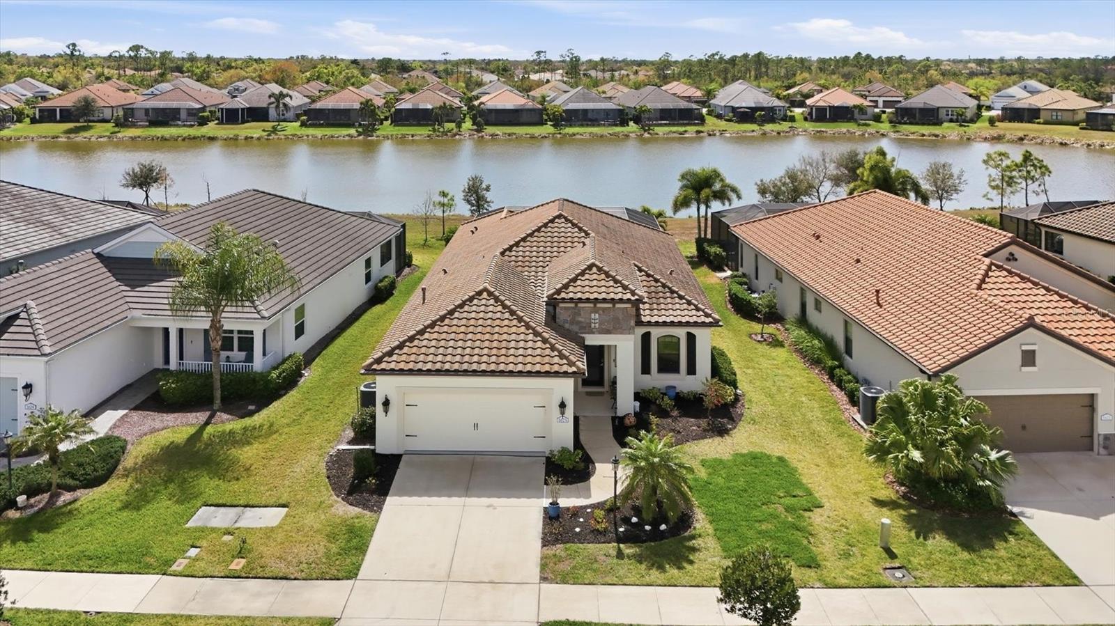 Beautiful maintained and upgraded 2019 White Star model with lake view. 3 bedroom plus den, 2 1/2 bathroom home with private pool and modern open floor plan with tray ceilings and crown molding. The home sparkles with ceramic tile flooring throughout and abundance of natural light. A stunning  kitchen with granite counter tops, stainless steel appliances and plenty of counterspace and gas stove makes entertaining fun. The split bedroom floor plan gives everybody privacy. The master suite enjoys the lake view a en-suite bath with dual sinks and generous walk in closet. The house is in an x flood zone, has whole house hurricane protection as roll down shutters, a Generac natural gas generator, surge protector and integrated security system to give a buyer complete serenity. Located in the Grand Palm Community with endless resort-style amenities and activities, ranging from a resort-style pool, splash pad, dog park, pickleball, tennis, playground, fishing piers and much more so residents can relax or stay active without even leaving the community.  
House has fresh paint inside and out. New hot water circulation with pump and timer, New front load GE washer and dryer, New Pure MX ultraviolet light in HVAC, Monkey Bar 4'x8' shelves in Garage rated at 750 pounds, New front door with glass and new pool pump.Turnkey furnished (exc. brown file cabinet in office)