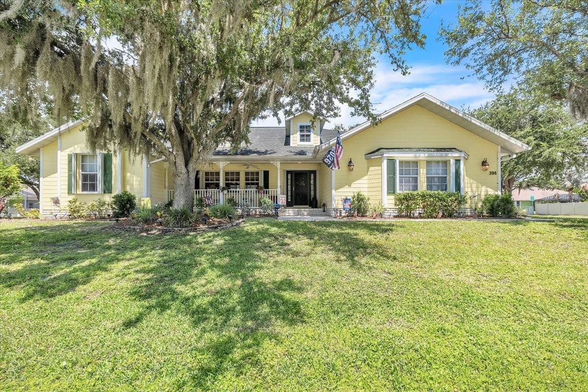 Welcome to this charming and beautifully maintained 4-bedroom, 2-bath, 2-car garage pool home, ideally located in the heart of Port Charlotte on an oversized corner lot shaded by mature trees. Offering 2,396 square feet of living space, this inviting residence features a spacious and versatile floor plan with a family room, living room, and formal dining room—perfect for both everyday living and entertaining. A circular driveway enhances the home's curb appeal while providing added convenience and a welcoming first impression. The cheerful exterior, mature landscaping, and cozy front porch create an inviting setting to enjoy your morning coffee or unwind at the end of the day. For added peace of mind, the home has been thoughtfully updated with a Briggs & Stratton generator, a 500-gallon underground propane tank with a dedicated gas line to the generator, roll-down wire shutters and accordion shutters on the rear lanai, a newer A/C system, water heater, and a shingle roof replacement. Step inside through the welcoming foyer, where beautiful wood flooring, abundant natural light, and an elegant arched opening create a warm introduction to the home. The foyer flows seamlessly into the spacious living and dining rooms, where soaring ceilings and large windows enhance the bright, open atmosphere. Sliding glass doors lead directly to the lanai and pool area, creating a seamless connection between indoor and outdoor living spaces. Warm finishes, architectural details, and a flexible layout make these rooms both stylish and functional. At the heart of the home, the kitchen combines beauty and practicality with raised-panel wood cabinetry, stainless steel appliances, generous counter space, and abundant storage. A breakfast bar provides additional seating, while the sunny breakfast nook, surrounded by windows overlooking the pool, offers the perfect spot for casual meals. Adjacent to the kitchen, the family room features a vaulted ceiling and plentiful natural light, creating a comfortable gathering space for family and friends. Privately situated on one side of the home, the spacious owner's suite serves as a peaceful retreat. French doors provide direct access to the pool lanai, while a hallway lined with dual walk-in closets offers exceptional storage and organization. The en-suite bath features dual vanities, a relaxing soaking tub, and a Roman shower. On the opposite side of the home, three generously sized guest bedrooms offer comfortable accommodations for family and visitors, each with walk-in closets. A full guest bath also serves as a convenient pool bath, providing direct access to the outdoor living area and enhancing functionality for entertaining and everyday enjoyment. The outdoor living area showcases a beautiful screened-in pool and spa all surrounded by a spacious deck that offers plenty of room for lounging and entertaining. The expansive covered lanai provides a shaded seating and outdoor kitchen area—perfect for dining, grilling, or relaxing while overlooking the water. The expansive backyard offers a peaceful, park-like setting with mature shade trees and a dedicated fire pit area, perfect for relaxing or entertaining. This private outdoor retreat beautifully complements the home's pool and lanai. This home offers quick access to shopping, dining, and services along US-41, Gulf beaches and more.