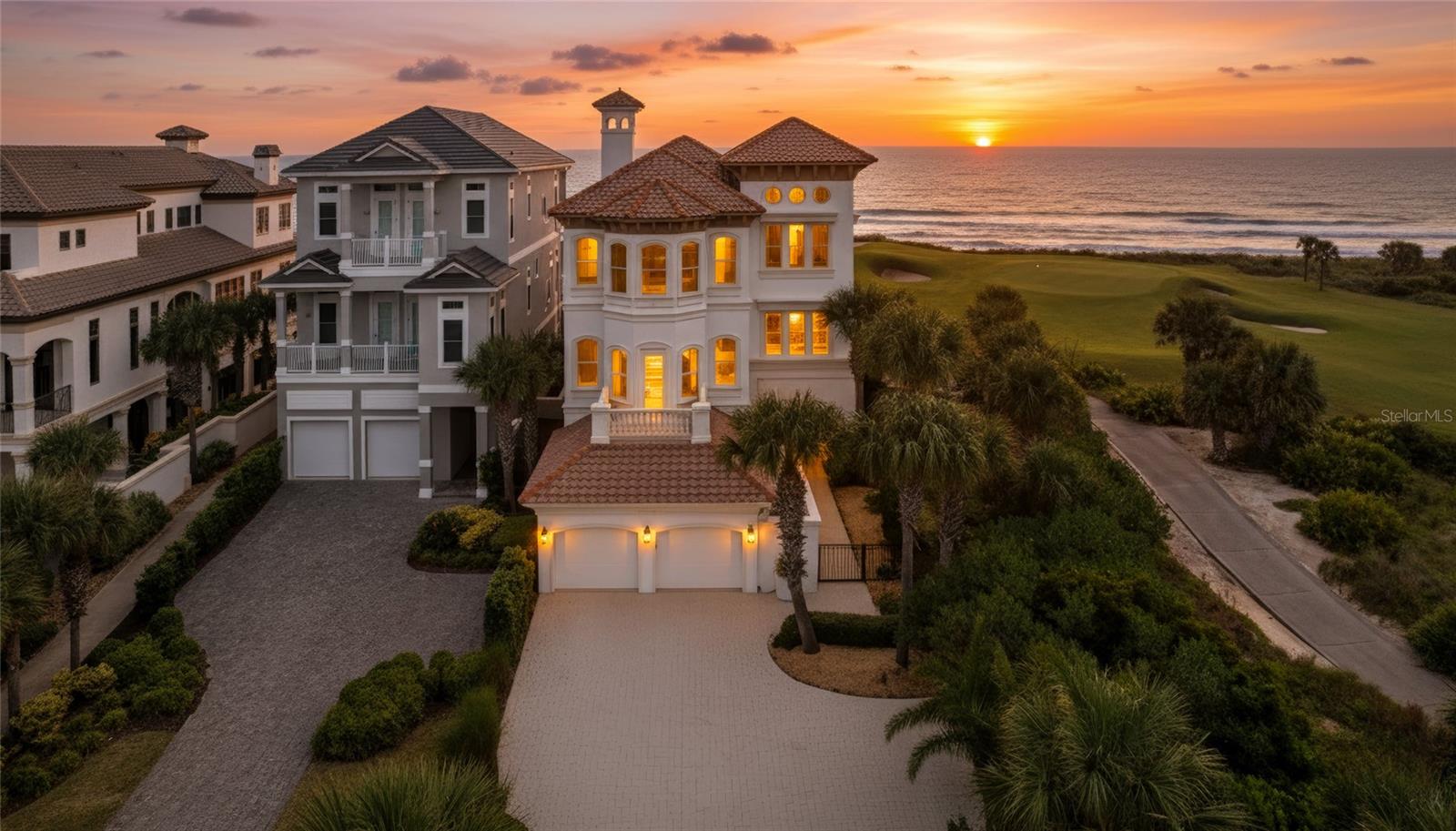 Perched on one of the most desirable oversized homesites in Hammock Beach, this 5300 living-square-foot, 6-bedroom, 5-bathroom oceanfront estate redefines coastal luxury with breathtaking panoramic views of the Atlantic Ocean and the Jack Nicklaus Signature Ocean Golf Course, highlighting holes 8 and 9. Wraparound balconies capture vibrant sunrises and serene sunsets, creating an idyllic setting for relaxation and entertaining. The top-floor owner’s suite, a private sanctuary, boasts stunning ocean vistas, a spa-inspired ensuite, generous walk-in closets, and an adjacent leisure room, while a main-level guest suite with a sunset-facing balcony comforts visitors. The open chef’s kitchen, seamlessly integrated with the grand room, features top-tier appliances, a large center island, and custom cabinetry, all framed by floor-to-ceiling windows and doors that flood the space with natural light and ocean views. An elevator provides effortless access to all levels, complemented by smart home technology for lighting, climate, and security control. The first-floor entry pool level serves as a cabana area with additional leisure space, featuring a wet bar, an ensuite bedroom, a full pool bathroom, and two additional bedrooms for ultimate guest comfort. Outside, a heated pool and spa anchor a spacious entertainment area, complete with a summer grilling station featuring an Evo flat-top grill. Electric storm shutters and energy-efficient windows enhance safety and sustainability, while private beach access leads directly to Hammock Beach’s pristine shoreline. As part of a maintenance-free community, residents enjoy exclusive access to an amenity center with pool, kitchen and social spaces. Nestled in the highly desirable Hammock Beach community, just minutes from Hammock Beach Resort vibrant dining and amenities, this ocean estate offers an unparalleled lifestyle of elegance, leisure, and natural beauty, complete with air conditioned garage space equipped with custom storage solutions.