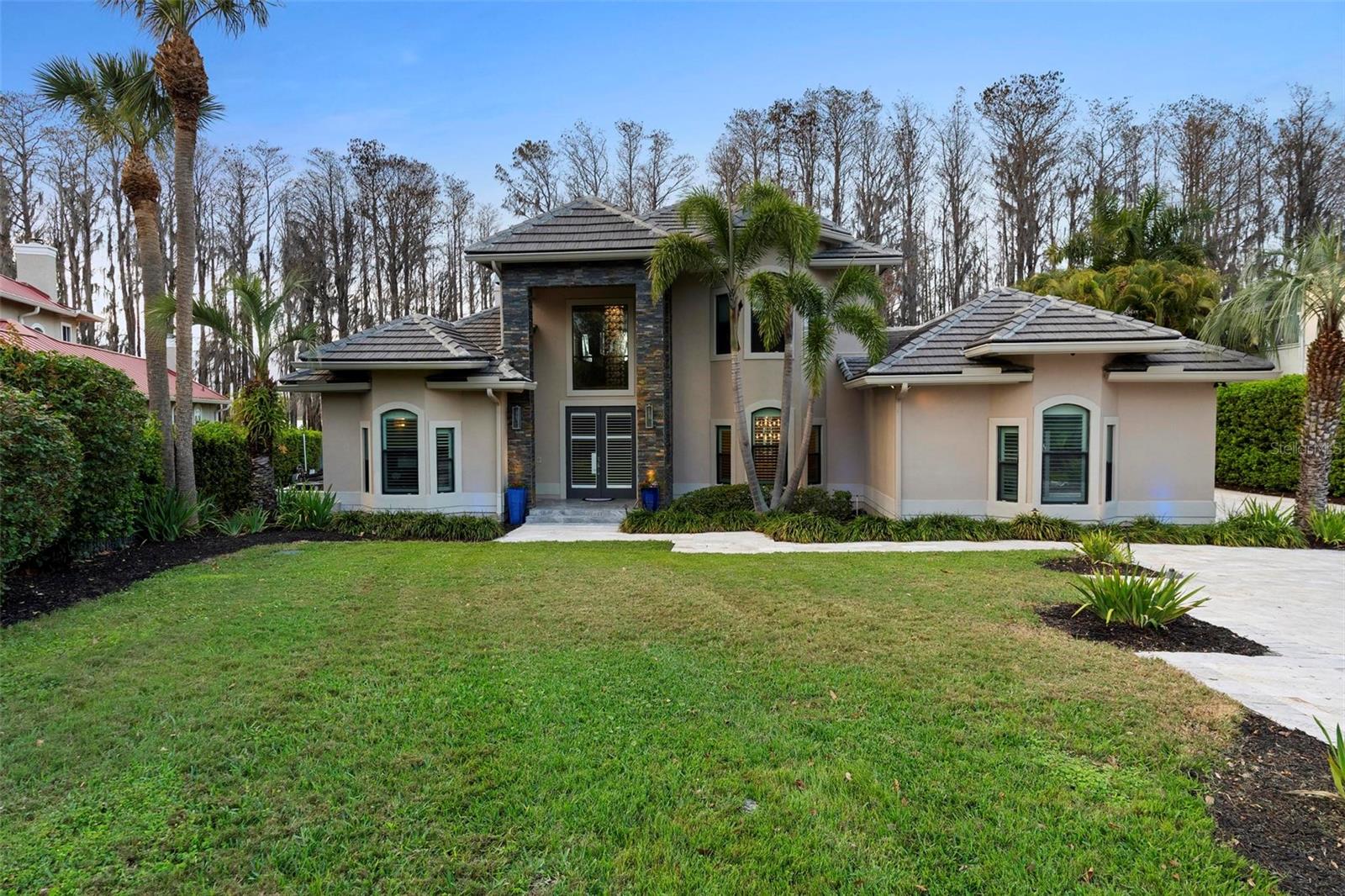 One or more photo(s) has been virtually staged. LAKEFRONT GATED HOME, located in North Bay Neighborhood in Dr. Philips with  access to Butler Chain of lakes. This remarkable home provides stunning marble and Travertine floors throughout, Gourmet kitchen, Gas Stove High-M Appliances, Splendid walking Wine Cellar with two Wood Burning Fireplaces and Stunning view in the Master Bathroom.     
 The water Access provides a covered Boat Dock, Boat hoist, Jet ski port - Everything designed for Lake Life Style entertainment with the family.
Home provided with a gas emergency generator and light system in the front, back and dock.