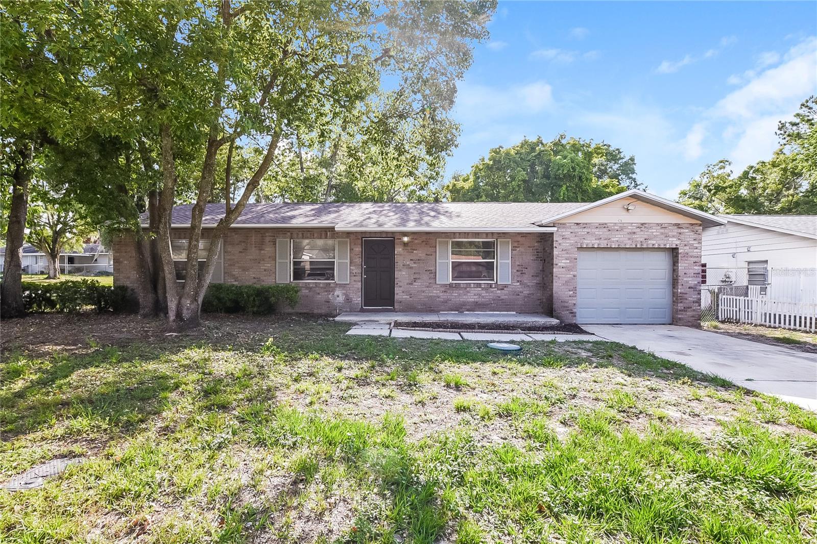 Welcome to this well-maintained 3-bedroom, 2-bath home situated on a spacious oversized lot in the heart of Apopka. This charming residence features an open and inviting floor plan with a large living and dining area, abundant natural light, and durable flooring throughout the main living spaces. The kitchen offers ample cabinet and counter space and flows seamlessly into the living area, making it ideal for everyday living and entertaining. The primary suite includes a private bath, while two additional bedrooms provide flexibility for guests, a home office, or growing households. Enjoy Florida living year-round from the expansive screened porch overlooking the large backyard shaded by mature trees. The generous outdoor space offers endless possibilities for recreation, gardening, and outdoor gatherings. Conveniently located near shopping, dining, parks, schools, and major roadways, this home combines comfort, space, and value in a desirable location. Don't miss this opportunity to make it your own.