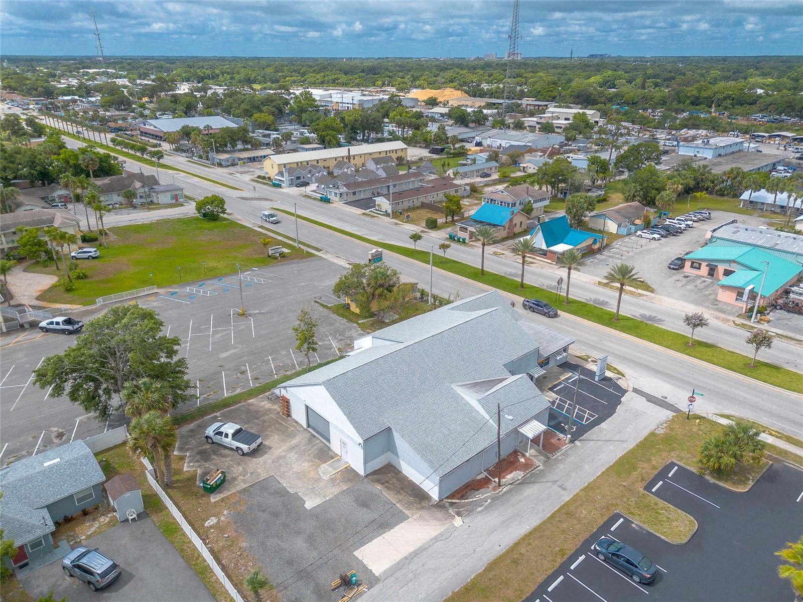 New Price - Prime commercial opportunity in redevelopment zone. This 7,172 sq ft concrete block building sits on a 0.33-acre corner lot in a high-traffic corridor along Ridgewood Avenue (U.S.-1). Zoned for retail or mixed commercial use, the property has been updated and permitted, offering exceptional versatility rarely found on the market today. The building’s layout combines retail, office, and warehouse space, a unique mix that suits countless business models and is easily dividable into multiple revenue streams. The front retail area (approx. 4,500 sq ft) features a large bar top island, soundproof viewing window, and partial soundproof wall offering visibility into the warehouse area while allowing for quiet operation in the retail space. The warehouse/workshop space (approx. 2,600 sq ft) includes a 12’x12’ automatic garage door (2020) and generous open floor area for production, storage, or distribution needs. A large executive office with a private restroom, plus three additional restrooms (four total) and a kitchenette, provide excellent functionality for staff and customers. The property also includes a separate music studio space with a private entrance—ideal for creative or specialty use, with potential for restoration or customization to fit your business vision. Recent upgrades include a new roof (2020), new plumbing (2020), new HVAC (2022), new electric (2019), and new vinyl flooring throughout. Additional highlights include an insulated attic, ADA-compliant restrooms, and a large, highly visible monument sign for maximum exposure. Located within an Opportunity Zone, this property offers potential tax advantages for investors. All improvements are permitted and up to code. With its one-of-a-kind combination of retail, warehouse, and office space, there’s truly nothing else like it on the market so make a move and come see this great property today. There are no warranties expressed or implied.  All measurements are approximate.  Sq. footage received from the tax rolls.  All information recorded in the MLS is intended to be accurate but can not be guaranteed.  Buyer should check zoning for use restrictions.