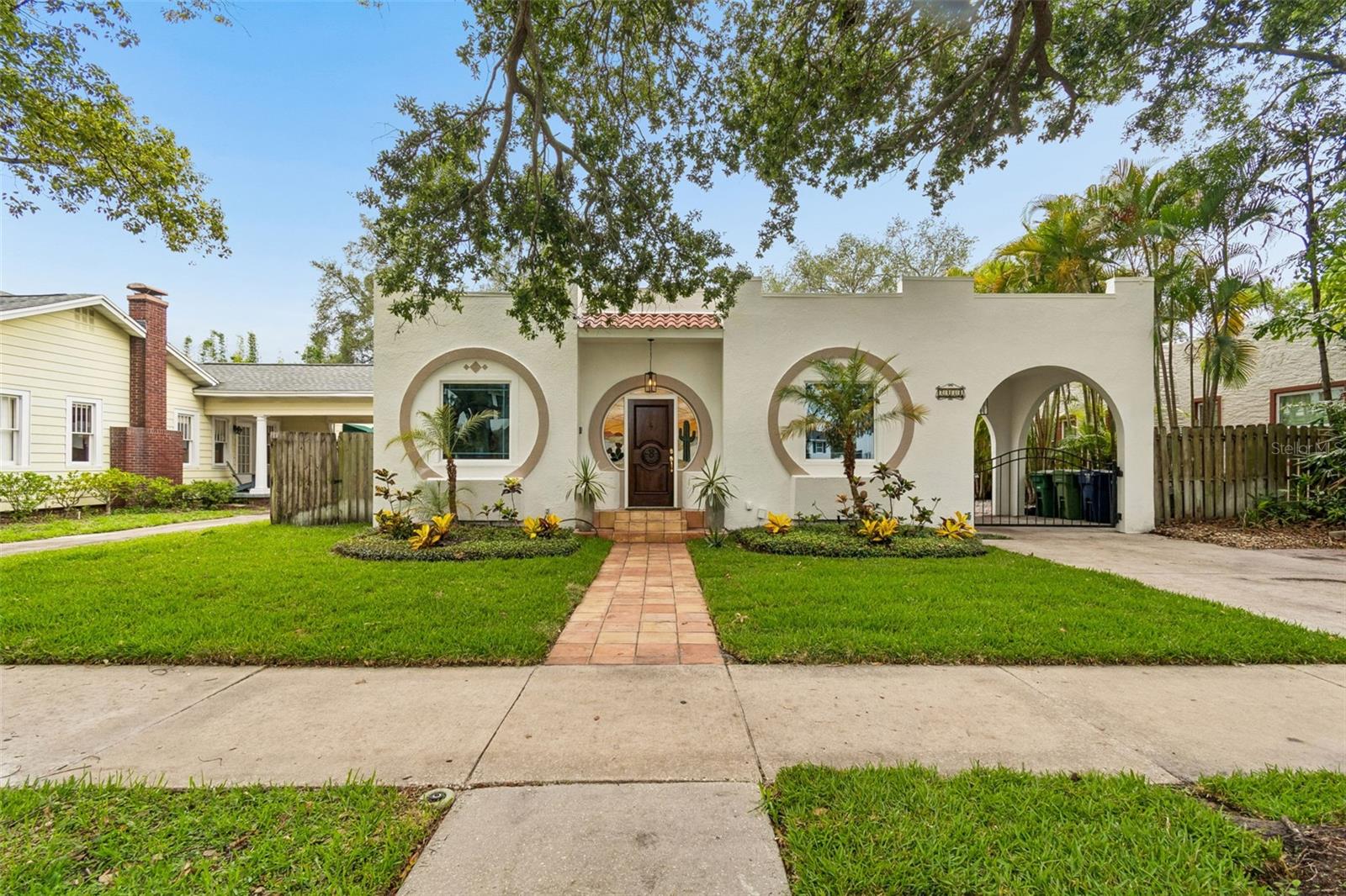 More photos coming soon.  Welcome to this charming, 1924, Mediterranean bungalow, offering timeless character, modern comfort, and exceptional flexibility. Located in one of South Tampa’s most walkable pockets, steps from iconic Bayshore Boulevard and the SOHO entertainment district. This property delivers the lifestyle buyers dream of: historic charm, a private resort-style backyard, and a well-equipped separate guest house.

Step through the lovely foyer framed by custom stained-glass windows, and your eyes are immediately drawn straight through the home to the sparkling heated pool and spa, a stunning first impression that sets the tone for the entire property.

The main home features 3 bedrooms and 2 bathrooms, a fantastic one-floor layout, and multiple flexible rooms ideal for a home office, additional guestroom or den. The large living room includes an original fireplace (currently decorative) and unique, architectural details.  A separate formal dining room adds elegance and function for gatherings. The spacious family room is filled with natural light from large windows and overlooks the beautifully landscaped backyard, pool, and guest house.

The kitchen has tons of cabinets, stone counters and a mosaic, tiled backsplash.  It also offers a large pantry, an eat-in counter, 3 pendant lights and double doors that open directly to the gated carport, making unloading groceries easy regardless of the weather. The primary suite has 2 large windows, 2 walk-in closets and an ensuite primary bathroom with shower, jetted tub and double vanities.  There are two additional nice sized bedrooms with large windows and ceiling fans. Gleaming floors, newer appliances, newer A/C units, and a freshly painted interior and exterior make this home truly move-in ready.

The guest house is a standout feature, perfect for extended family, visiting guests, or rental income. It has its own HVAC, 2 small bedrooms, a full bathroom, its own washer/dryer, and full independence from the main home.

Outside, the property lives like a private retreat. The inground, heated pool and spa, lush landscaping, and generous patio areas create a serene setting for relaxing or entertaining. The gated carport and extended driveway accommodate 3–4 vehicles, a rare convenience in this area.

The home is located in historic New Suburb Beautiful, one of the oldest and most desirable neighborhoods in South Tampa.  The home is in Flood zone X so no flood insurance is required.  Highly rated Mitchell, Wilson and Plant school district.  The home is vacant and ready for immediate occupancy.  You will definitely enjoy the historic charm, modern updates, and unbeatable walkability to some of Tampa’s best restaurants, shops, and iconic Bayshore Boulevard.