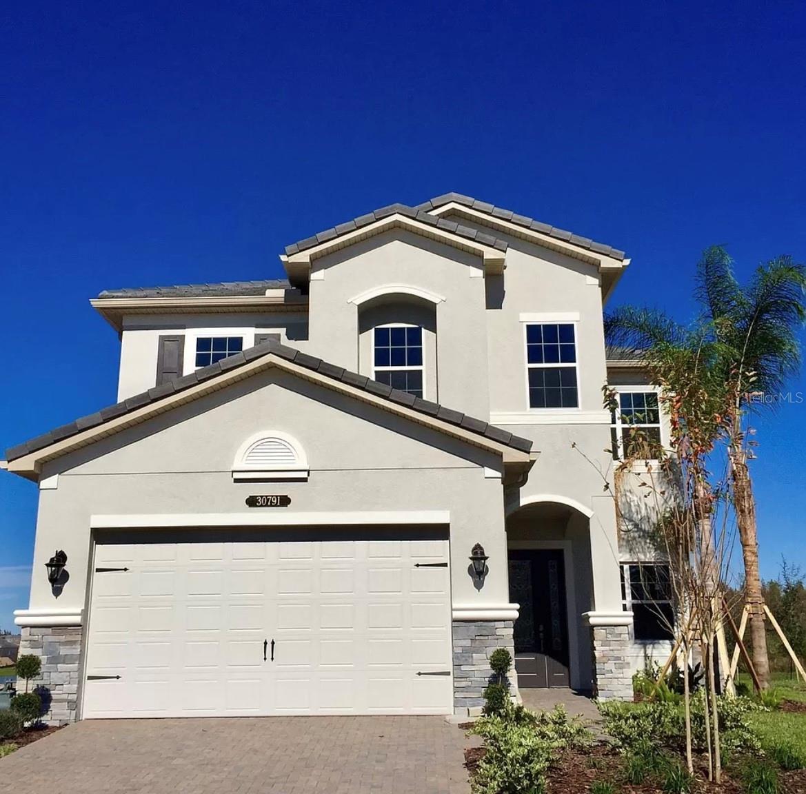 Welcome to this beautiful 5-bedroom, 4-bathroom home located in the highly desirable Ridge at Wiregrass Ranch. This spacious two-story residence features an open-concept floor plan designed for both comfortable everyday living and effortless entertaining.

Enjoy peaceful waterfront views from your backyard while taking advantage of the thoughtfully designed layout. The home offers a spacious kitchen that flows seamlessly into the living area, creating the perfect gathering space. The primary suite is a private retreat, complete with elegant tray ceilings and generous walk-in closets.

Located in the heart of Wesley Chapel, this sought-after community is just minutes from premier shopping, dining, top-rated schools, and the exceptional amenities The Ridge at Wiregrass Ranch has. Don't miss the opportunity to make this stunning waterfront home yours.