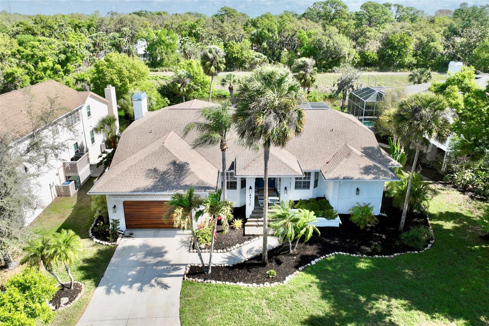 Welcome home to The Lakes 111. Where mature Oak trees surround this picturesque neighborhood. The Lakes has two community pools one heated with heated spas. A gym, a basketball court, playground, two tennis courts, and walking trails around a beautiful lake. Truly making you feel like you are in a different world. Nestled in the back of this highly desirable neighborhood. You will find a beautifully updated modern 5 bed plus office / 3.5 bath home. This expansive home has nearly 3100 ft.² of freshly painted beauty. It features an updated kitchen and bathrooms, quartz countertops, high end stainless steel kitchen appliances with a wine fridge. The quartz wood burning fireplace is a must for chilly winter nights. You will fall in love with the master suite. It encompasses the whole right wing of the house with 3 closets and master bathroom. New mechanicals, including HVAC two years old, energy efficient heat pump/water heater less than one year old and energystar pool pump that is three months old. Hurricane rated garage door, windows and doors. Here you can truly live the indoor outdoor lifestyle with 3 fully opening pocket slinging glass doors. These doors open onto the expansive patio/pool deck. Fully screened in pool cage, outdoor kitchen with quartz countertops , outdoor shower and both shaded or sunny lounging areas. Take your pic. 
Or you can sit by the custom out door fire pit and overlook the picturesque views of Phillipee Creek with its abundant wildlife. No neighbors behind you!!