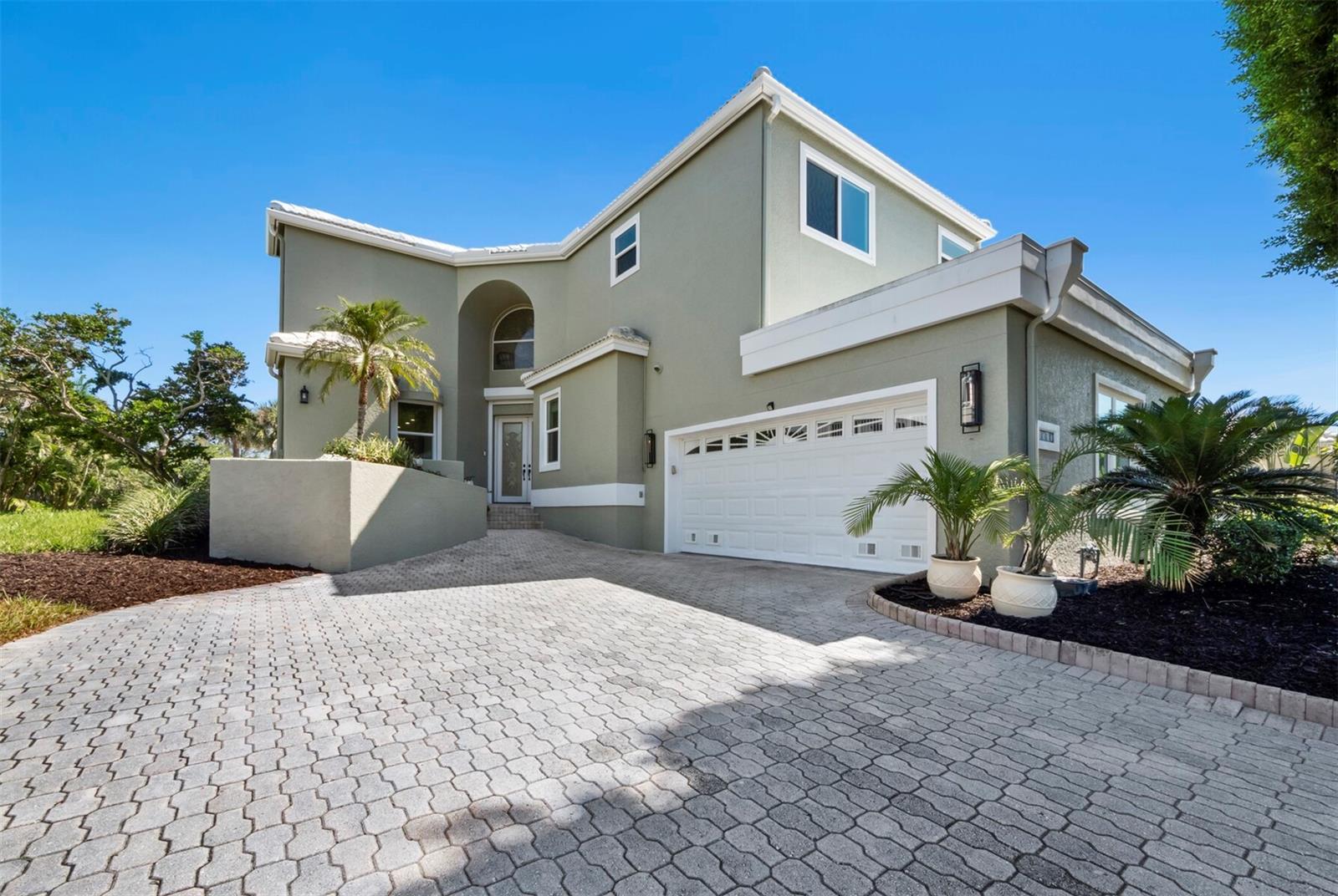 Under contract-accepting backup offers. Elegant 5BR/5BA home in the gated community of Corey’s Landing within Bay Isles on Longboat Key. With over 4,500 sq ft, this spacious two-story residence offers open living areas, soaring ceilings, and refined design for both comfort and style. The light-filled great room with 22-ft ceilings opens to a gourmet kitchen with stone countertops, breakfast bar, and stainless-steel appliances. The main-level primary suite features pool access, dual vanities, soaking tub, and walk-in shower. A fifth bedroom or office, full bath, laundry room, and elevator complete the first floor. Upstairs includes three en-suite bedrooms, including a guest suite with private balcony and golf course and bay views. Outdoor living includes a screened lanai, heated pool and spa, and lush tropical landscaping. Updates include 2018 roof, new A/C (2023), tankless water heaters, and new pool/spa motors. Owners enjoy deeded beach access at the Bay Isles Beach Club plus community tennis, pool, spa, kayak launch, and 24-hour gated security. Close to the Longboat Key Club, offering world-class golf, tennis, marina facilities, dining, and a private Gulf-front beach experience, as well as the shops and restaurants of St. Armands Circle.