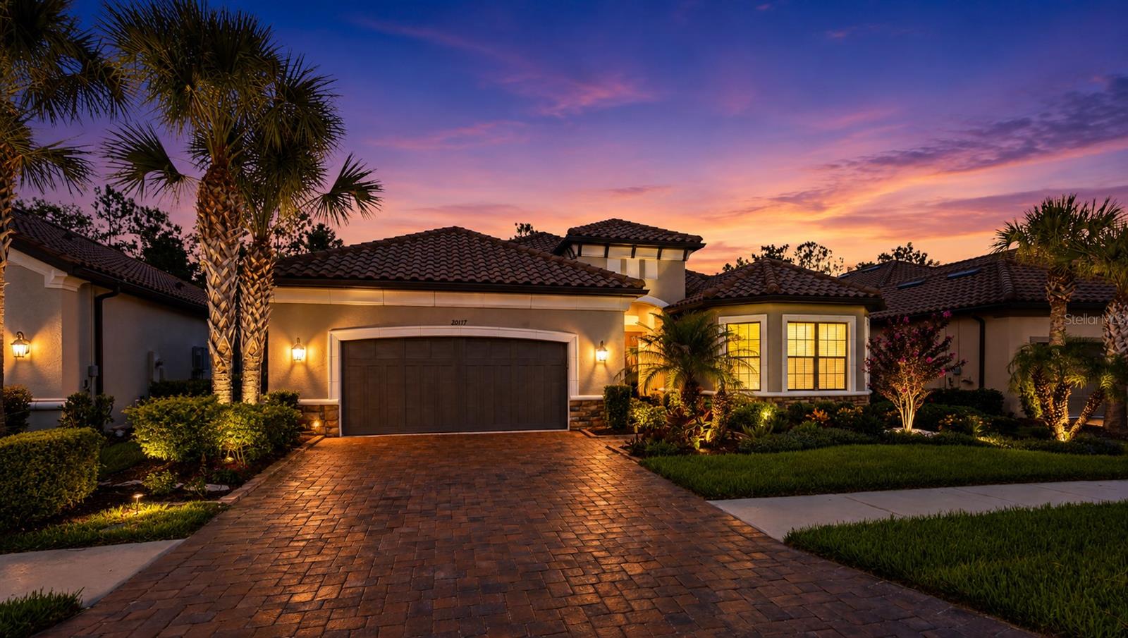 Perfectly positioned on a breathtaking conservation homesite, this spacious Pallazio floor plan by Taylor Morrison offers a rare combination of privacy, luxury, and resort-style living. Beautifully maintained home featuring 4 bedrooms + den + 3 full baths, and 3,117 square feet of living space with an open-concept layout and built-in audio system is ideal for both everyday living and entertaining. The home's impressive curb appeal with brick paver driveway, walkway and plush landscape and lighting leading to the grand double-door entry, creating a welcoming and elegant arrival experience. Inside, you'll find a home rich in architectural detail, including 8-foot interior doors, 5¼-inch baseboards, 3¼-inch door casings, tray ceilings, recessed lighting, and upgraded designer chandeliers that elevate the home's upscale style. At the heart of the home is the gourmet kitchen featuring bright quartz countertops, upgraded wood cabinetry, and a large walk-in pantry. Premium stainless-steel appliances include a counter-depth French-Door Refrigerator, GE Cafe built-in stacked microwave/oven and convection oven with Air Fryer and a gas cooktop. A wine cooler in the island plus a beautifully custom dry bar in the living area further enhancing the home's entertaining capabilities. The spacious gathering room flows seamlessly into the gourmet kitchen and dining area. Large format upgraded 24" x 24" tile extends throughout the main living areas, offering both beauty and durability. The luxurious owner's suite features elegant, engineered wood flooring and a spacious, spa-inspired bathroom designed for ultimate relaxation. The oversized seamless glass walk-in shower, complete with dual shower heads and dual built-in shower seats, creates a true resort-style experience. Expansive dual vanities, a dedicated makeup vanity, and a custom-designed walk-in closet provide exceptional functionality while blending luxury, comfort, and high-end design. Engineered wood flooring in the front bedroom, adding elegance, and timeless appeal to two of the home's most desirable spaces. Designed for convenience as well as luxury, the home also features a large interior laundry room with ample workspace and cabinetry, extended two-car garage with water softener system and Termite control system. The centerpiece of the home is the spectacular outdoor living area. Overlooking a serene conservation setting with no rear neighbors, the expansive 17' x 30' extended lanai is enhanced by a panoramic screen enclosure showcasing unobstructed views of nature offering pre-plumbed setup for a kitchen. This exceptional outdoor retreat provides the perfect setting for relaxing while enjoying Florida's sunshine. Combining elegant design, thoughtful upgrades, exceptional indoor-outdoor living, this remarkable home offers a rare opportunity to enjoy the very best of the Esplanade lifestyle. Beyond the home itself, residents enjoy the exceptional lifestyle offered by Esplanade of Tampa, a premier gated, HOA maintenance-free community with no-CDD known for its beautiful tile-roof homes, resort-style amenities, and vibrant social atmosphere. Residents have access to a stunning clubhouse featuring an active lifestyle and entertainment program, a resort-style pool and spa, tennis court, pickleball courts, bocce ball courts, a fitness center, fire pit gathering areas, and scenic walking and nature trails. Esplanade is minutes from premier shopping, exceptional dining, entertainment and hospitals.
