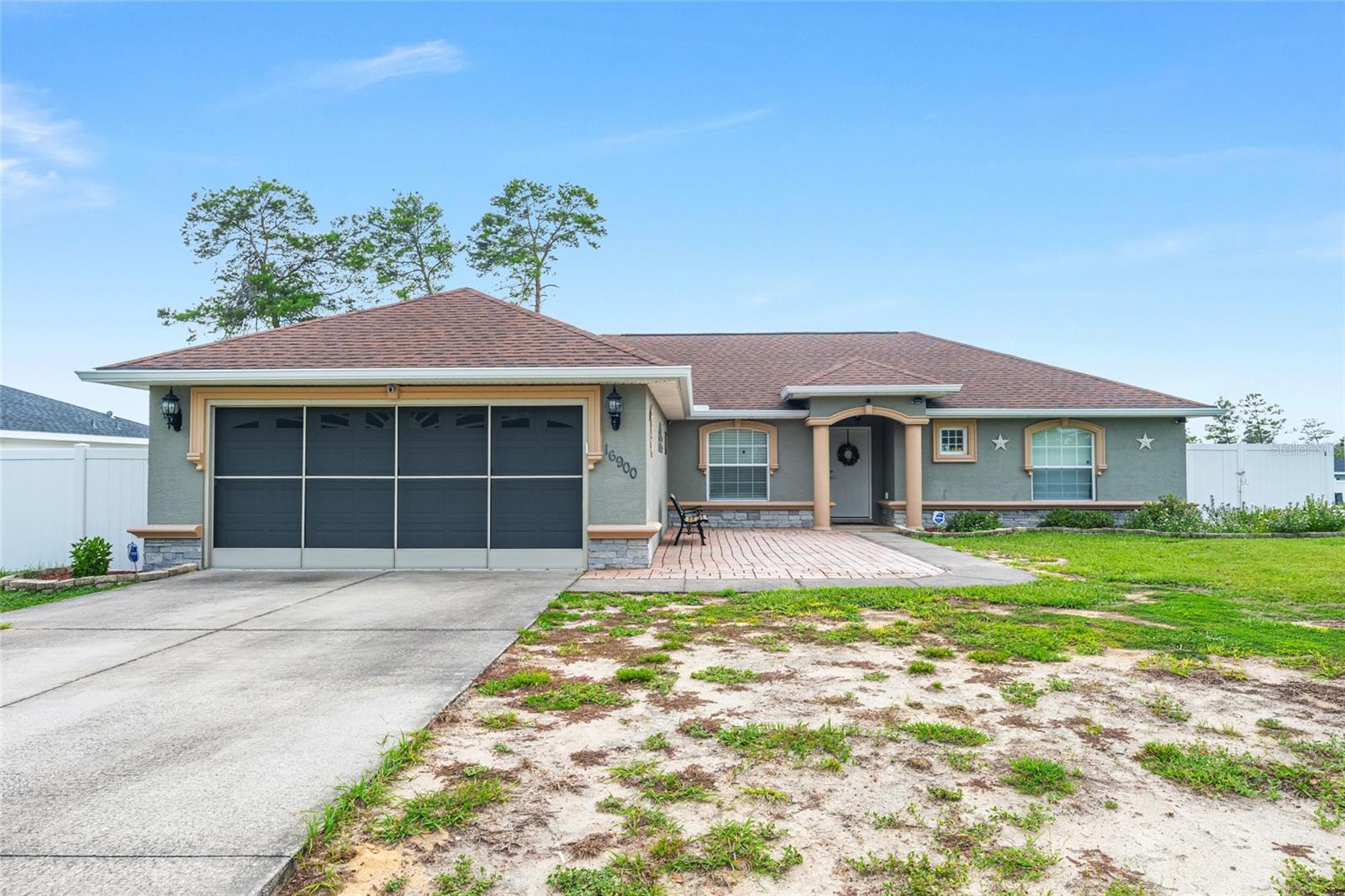 Welcome home! Beautifully updated 3-bedroom, 2-bath home w/ an attached 2 car garage & a fenced backyard in desirable Marion Oaks! Updates include a 2023 HVAC system, 2023 garage door opener, newer sliding glass door w/ built-in blinds, tiled garage w/ a screened garage door, newer toilets, & septic system pumped in February 2024. This move-in-ready home features a fully remodeled kitchen w/ updated cabinetry, quartz countertops, stylish backsplash, newer appliances (approximately 3 years old), & abundant recessed lighting. Enjoy additional updates: newer tile flooring throughout, vaulted ceilings, crown molding in living room, updated interior paint, newer ceiling fans, & a spacious primary suite w/ a walk-in closet, soaking tub, separate walk-in shower, & updated shower door. The guest bathroom has also been tastefully remodeled w/ custom tile, a new vanity, & updated fixtures. Step outside to a fully vinyl-fenced backyard w/ an extended patio, deck, storage shed, gutters surrounding the home, & attractive outdoor lighting. The washer, dryer, and electric fireplace are included. Don’t miss your chance to see this home and everything it has to offer — schedule your showing today!